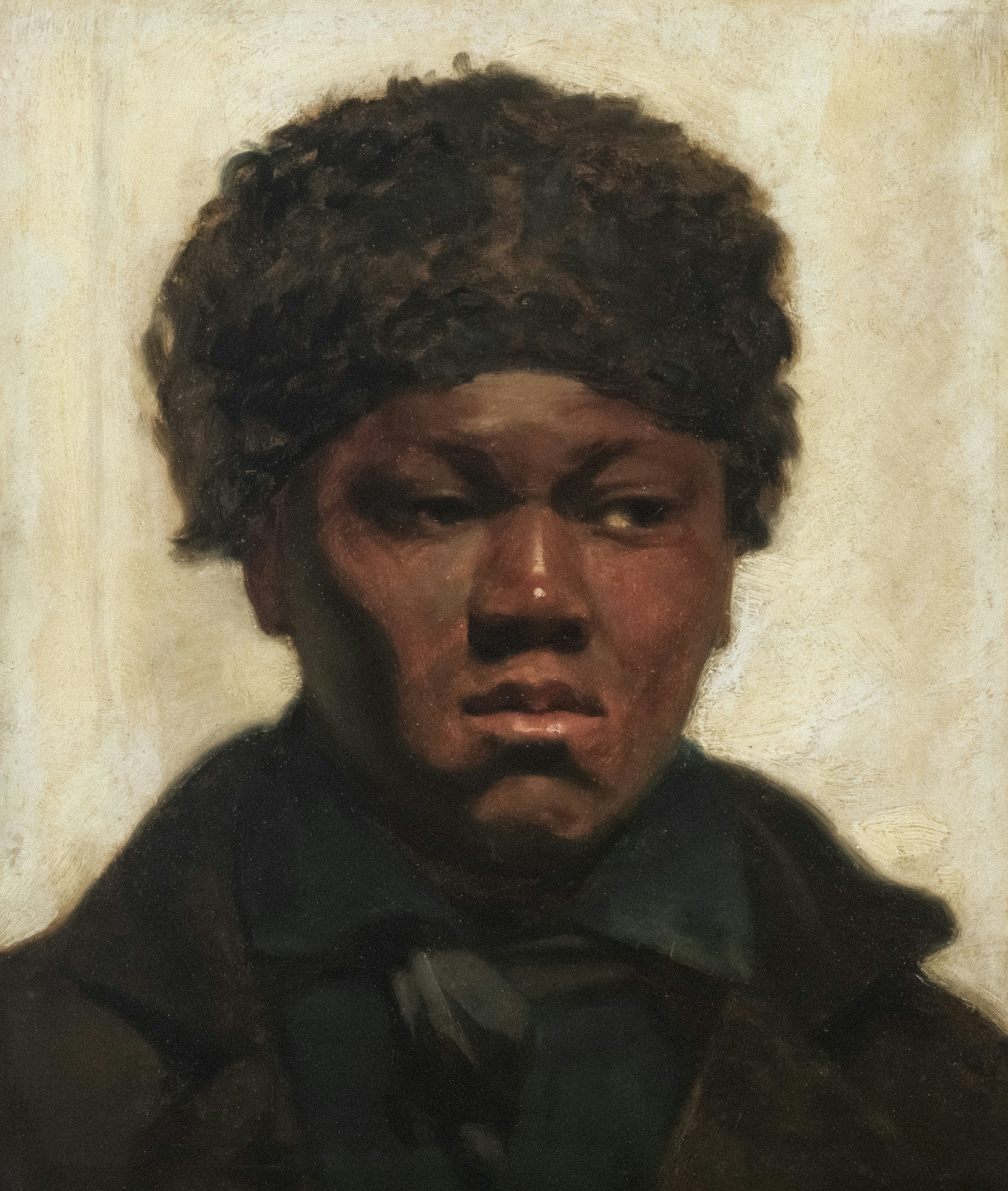 A young black man wearing a fur hat