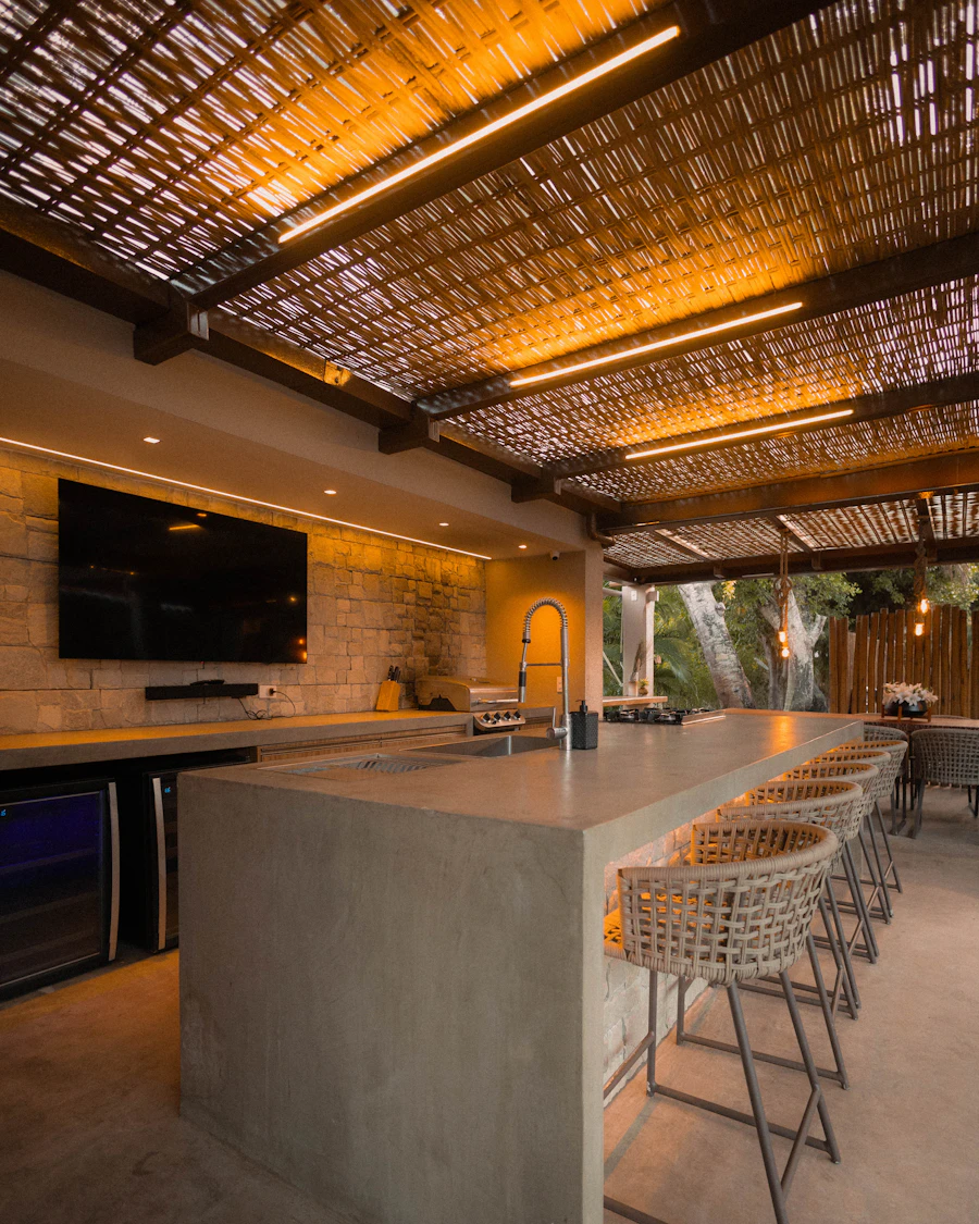 Dining table set on a terrace next to a built-in grill station