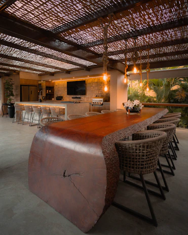 Large wooden table with chairs in outdoor dining area