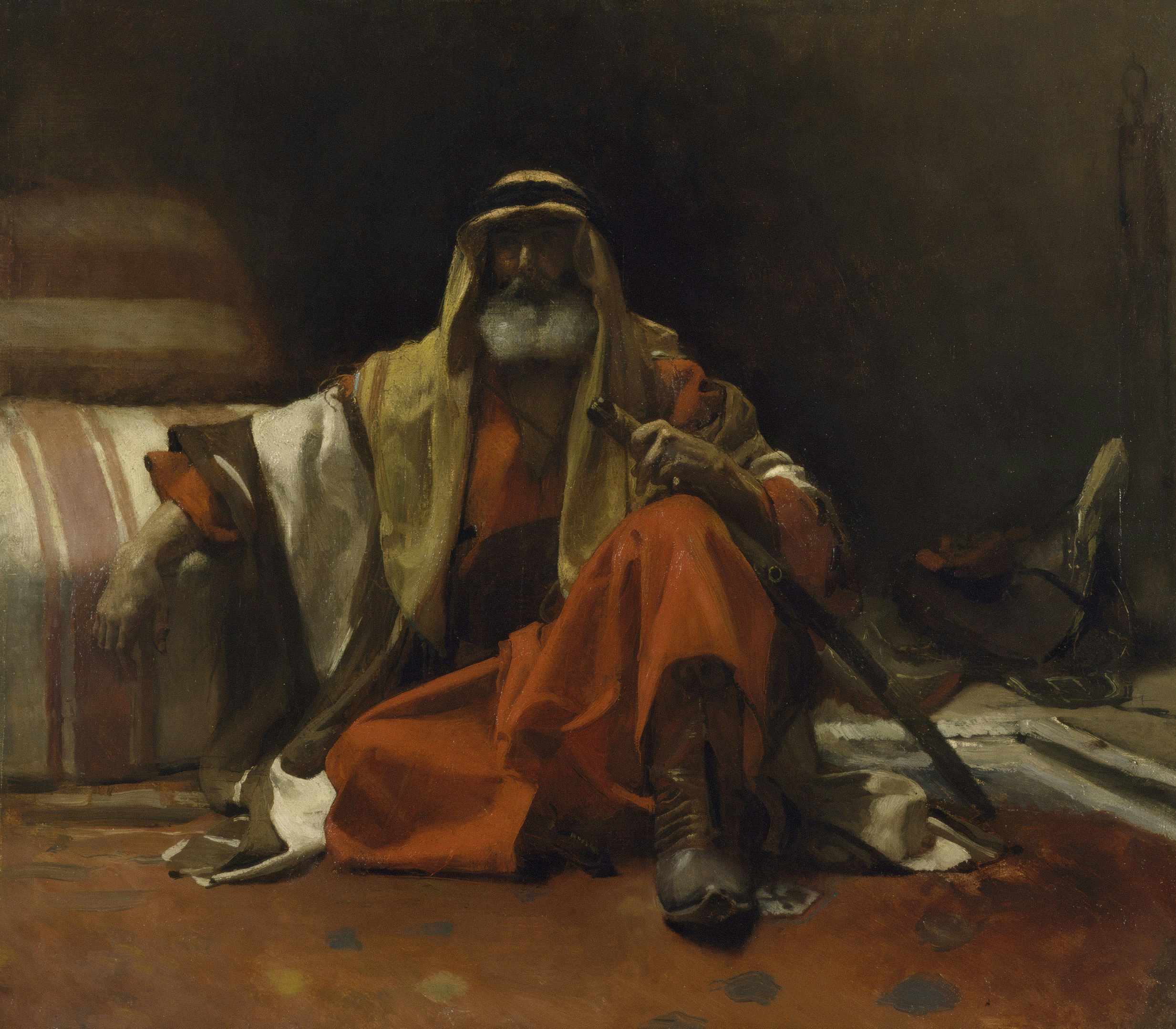 An old man in traditional clothing sits with a sword.