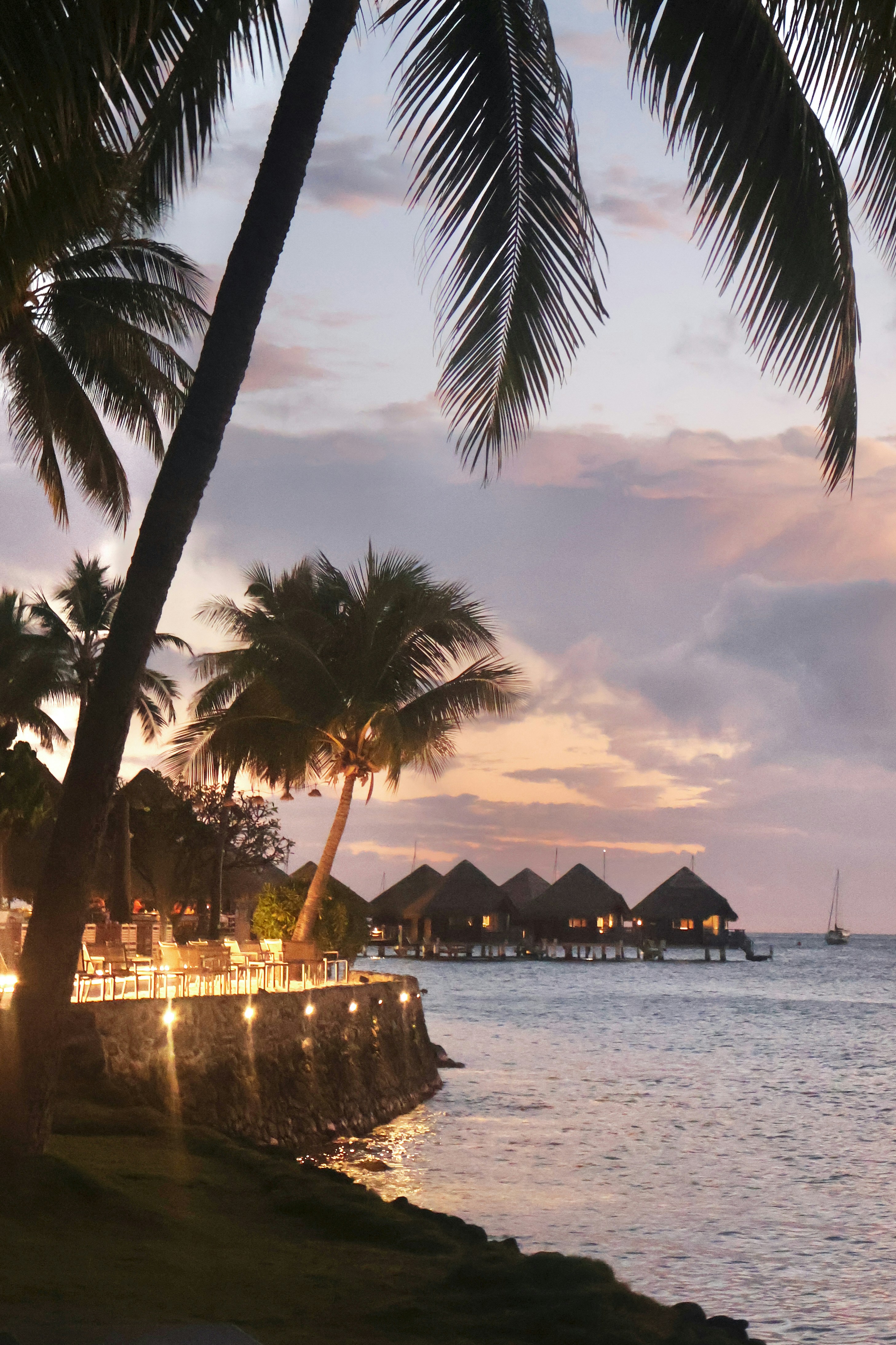 Tropical bungalows on the water at sunset