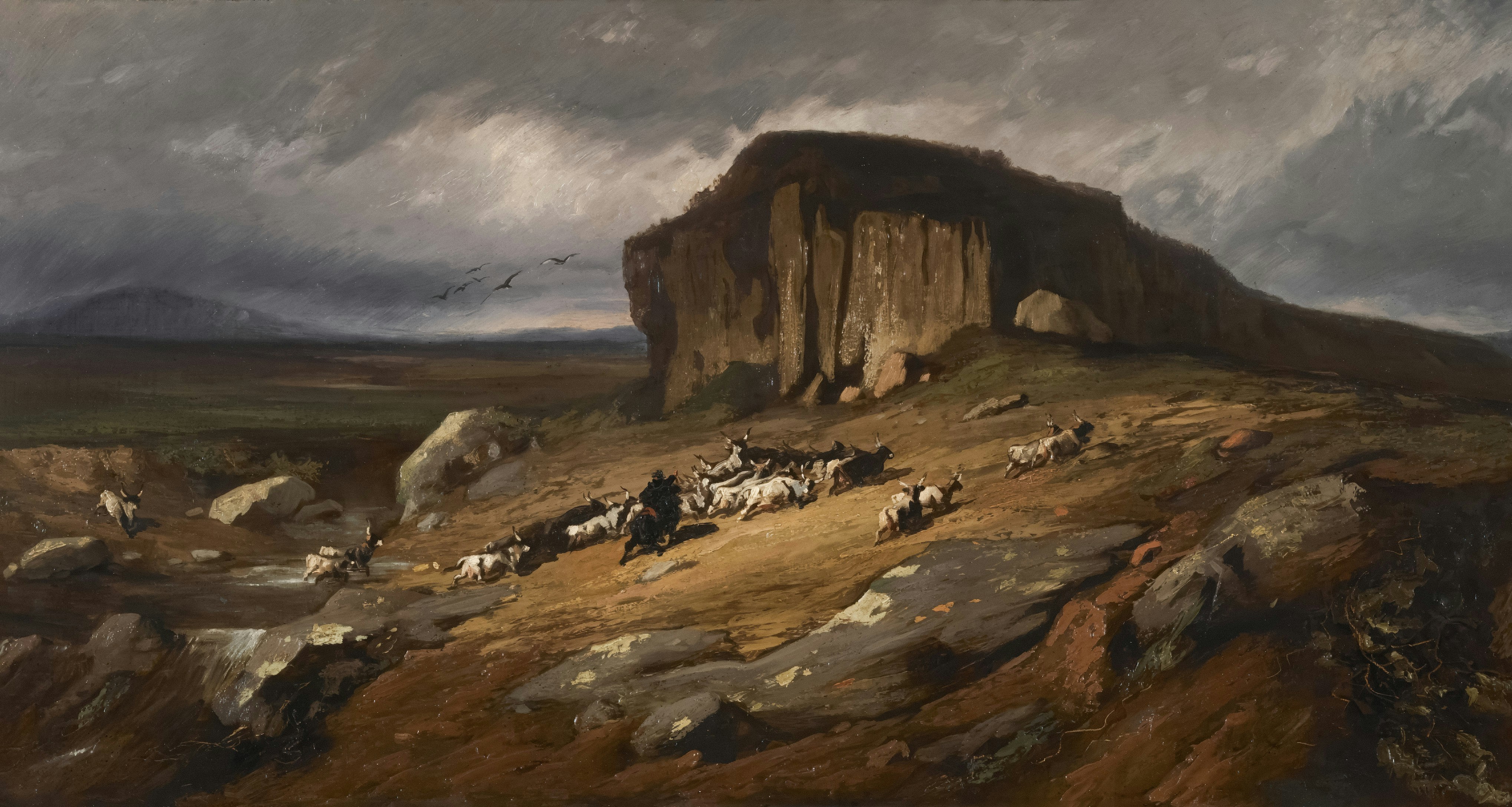 Shepherds with flock on a rocky hillside under stormy sky