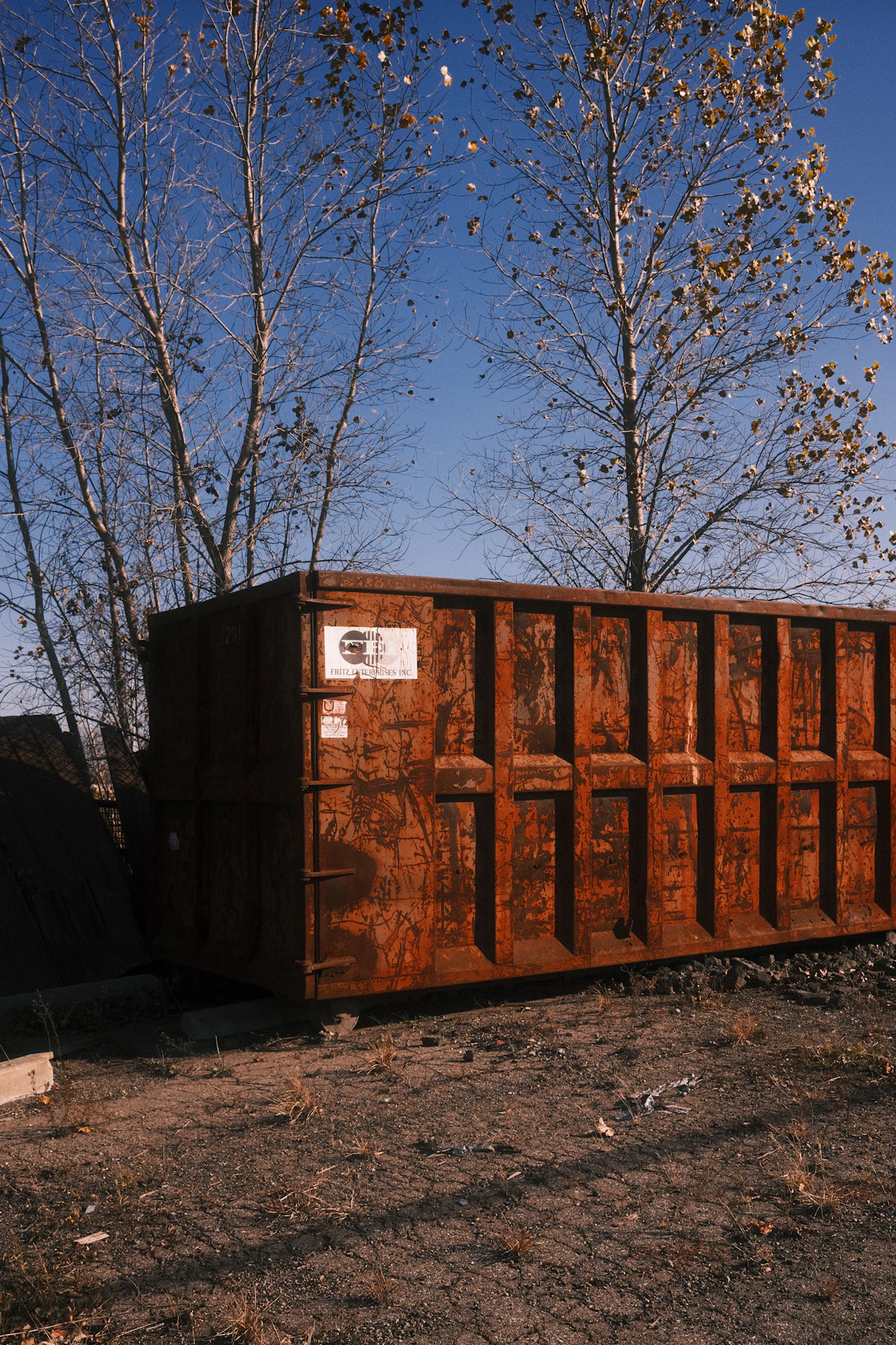 Real industrial roll-off dumpster sitting in an outdoor lot