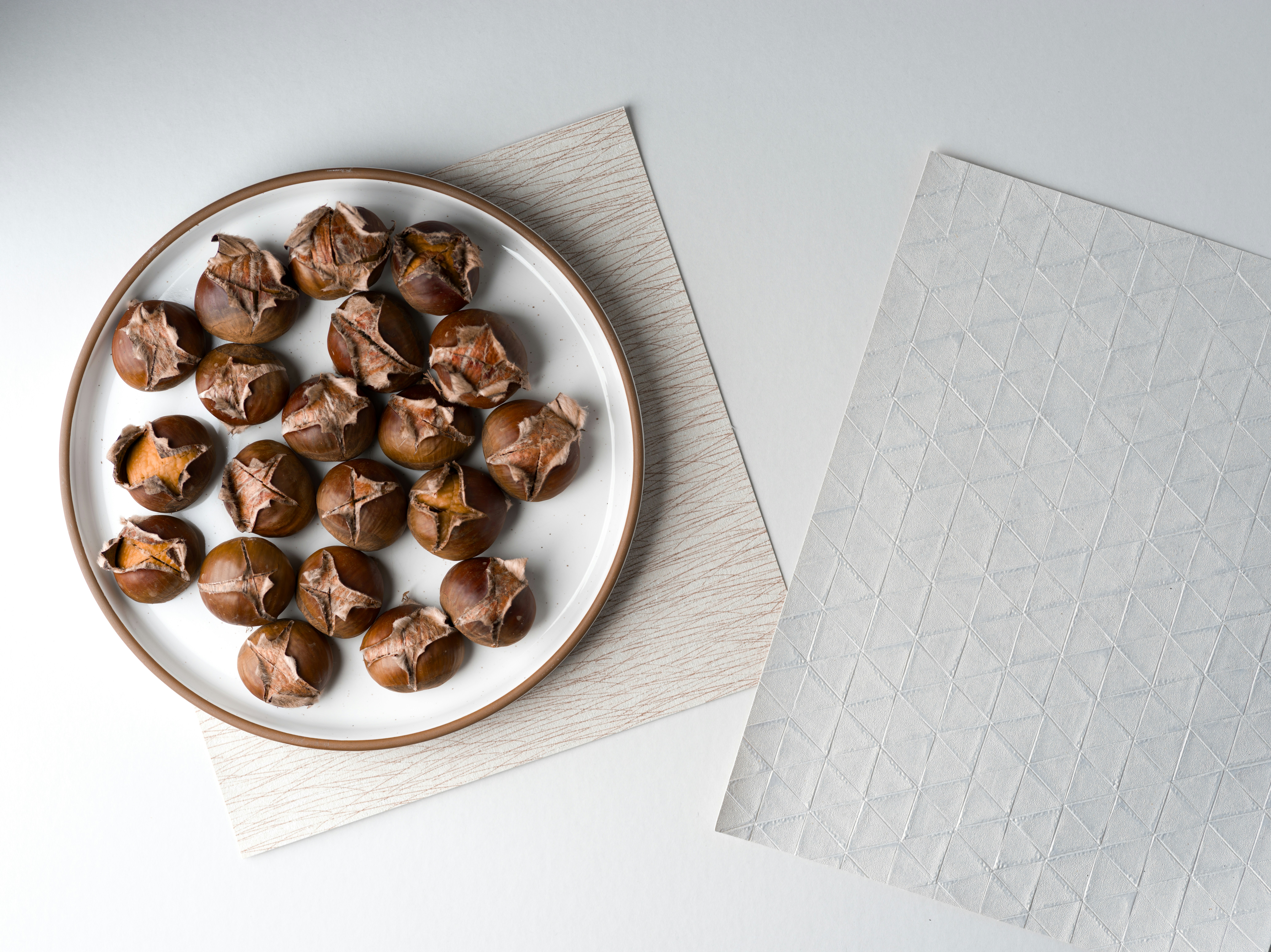 Roasted chestnuts on a plate with a napkin.