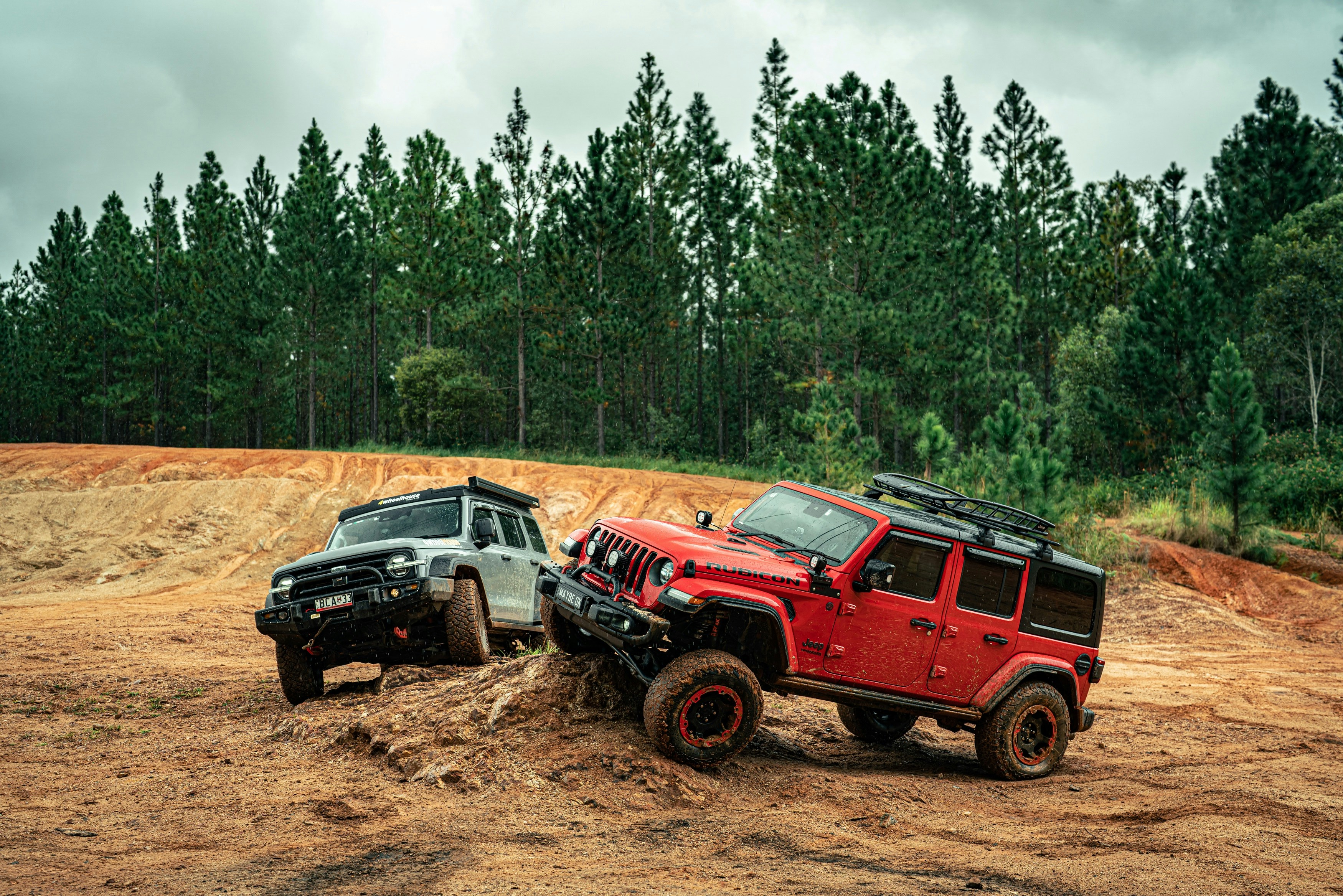 Two off-road vehicles navigating a dirt track