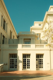 Cream colored building with large windows and balcony