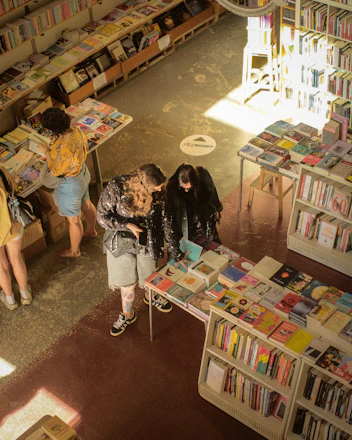 People browsing books in a well-stocked bookstore.