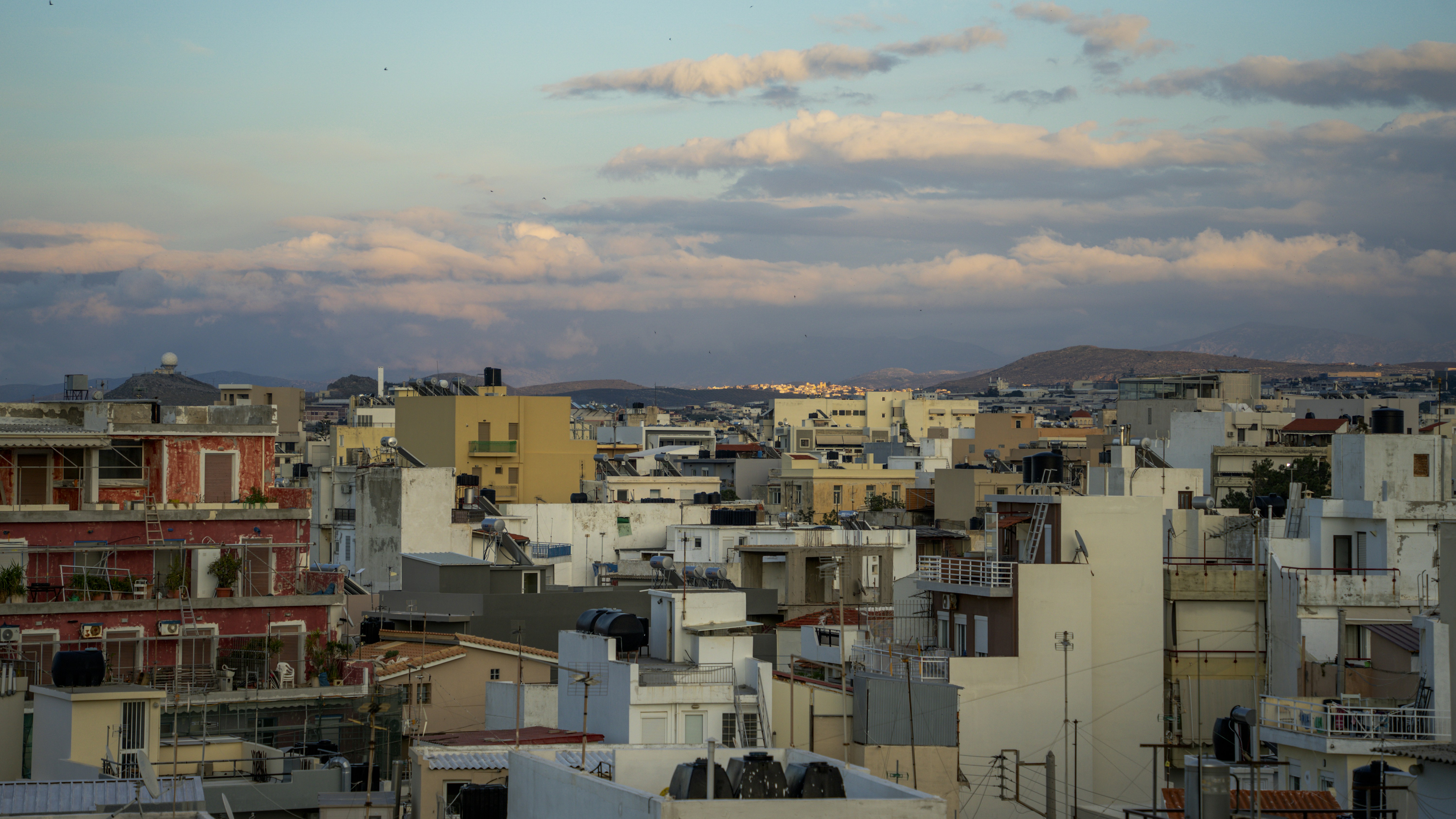 Rooftops and buildings under a cloudy sky