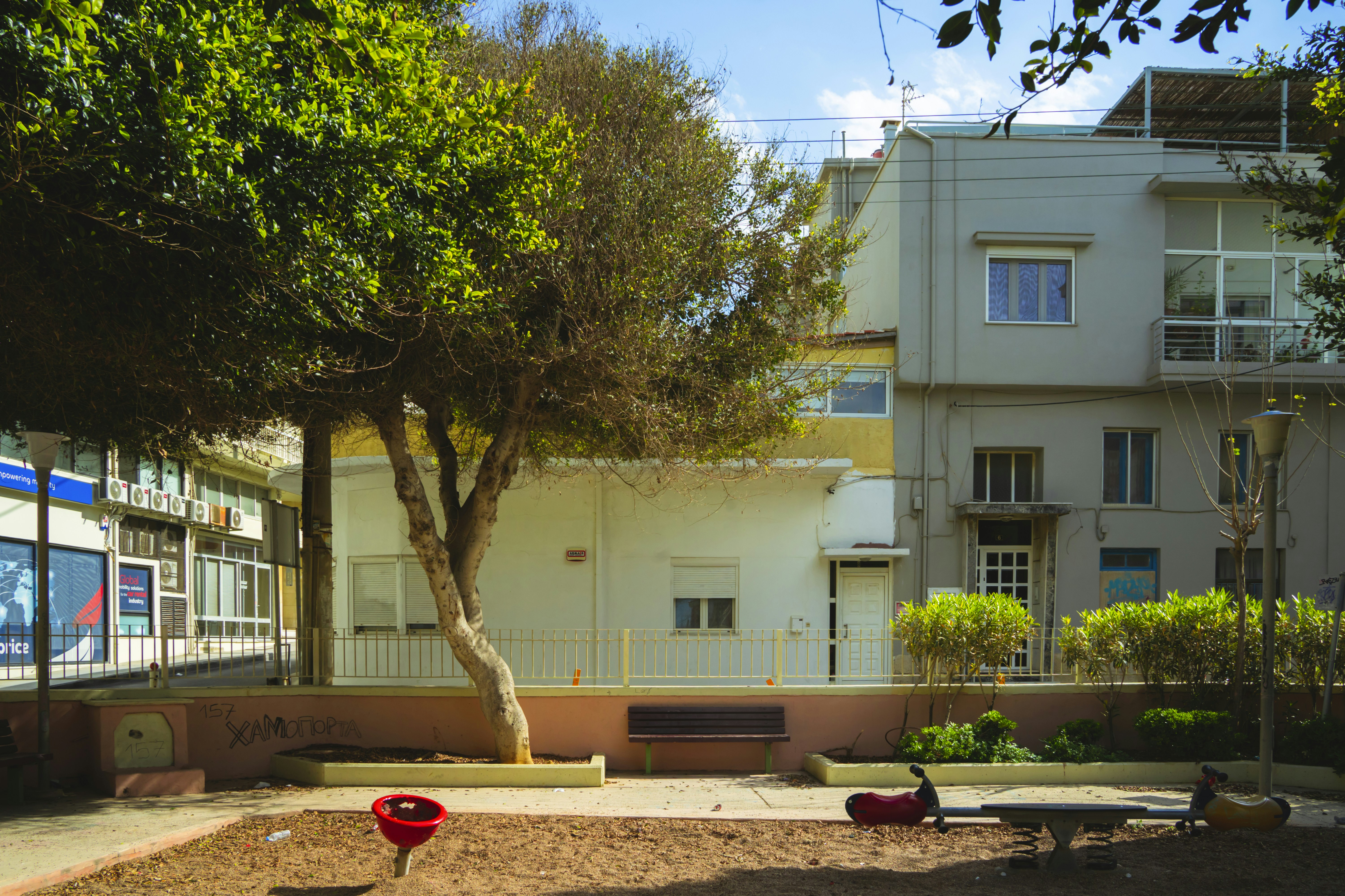 Small park area with trees and modern buildings