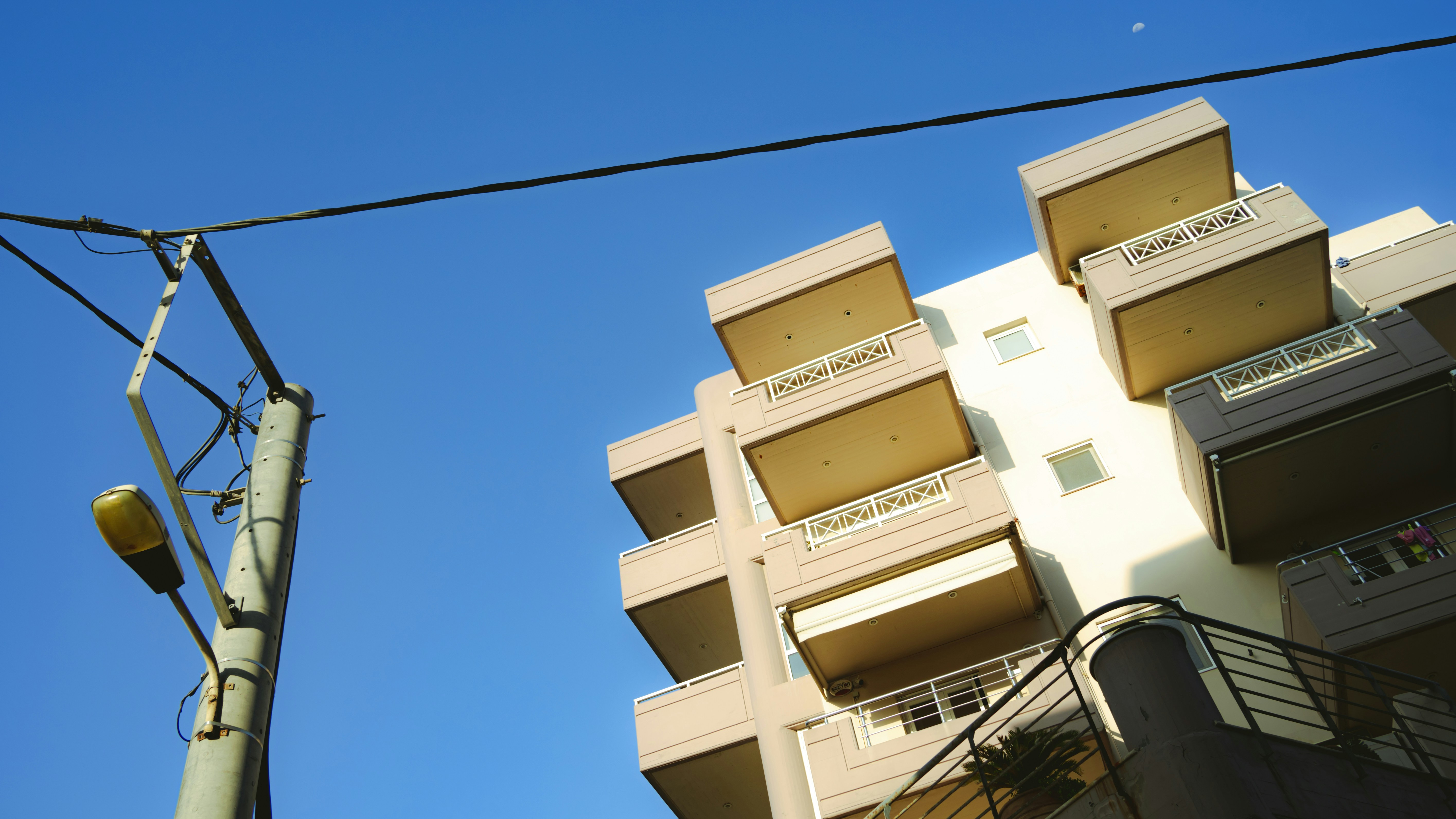 Modern apartment building with balconies against blue sky
