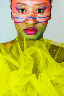 Woman with colorful face paint and glitter