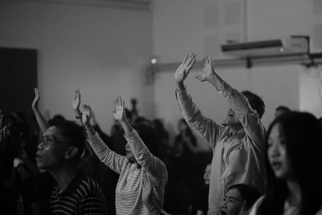 Diverse believers worshipping with raised hands