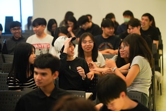 A group of young people sitting in chairs