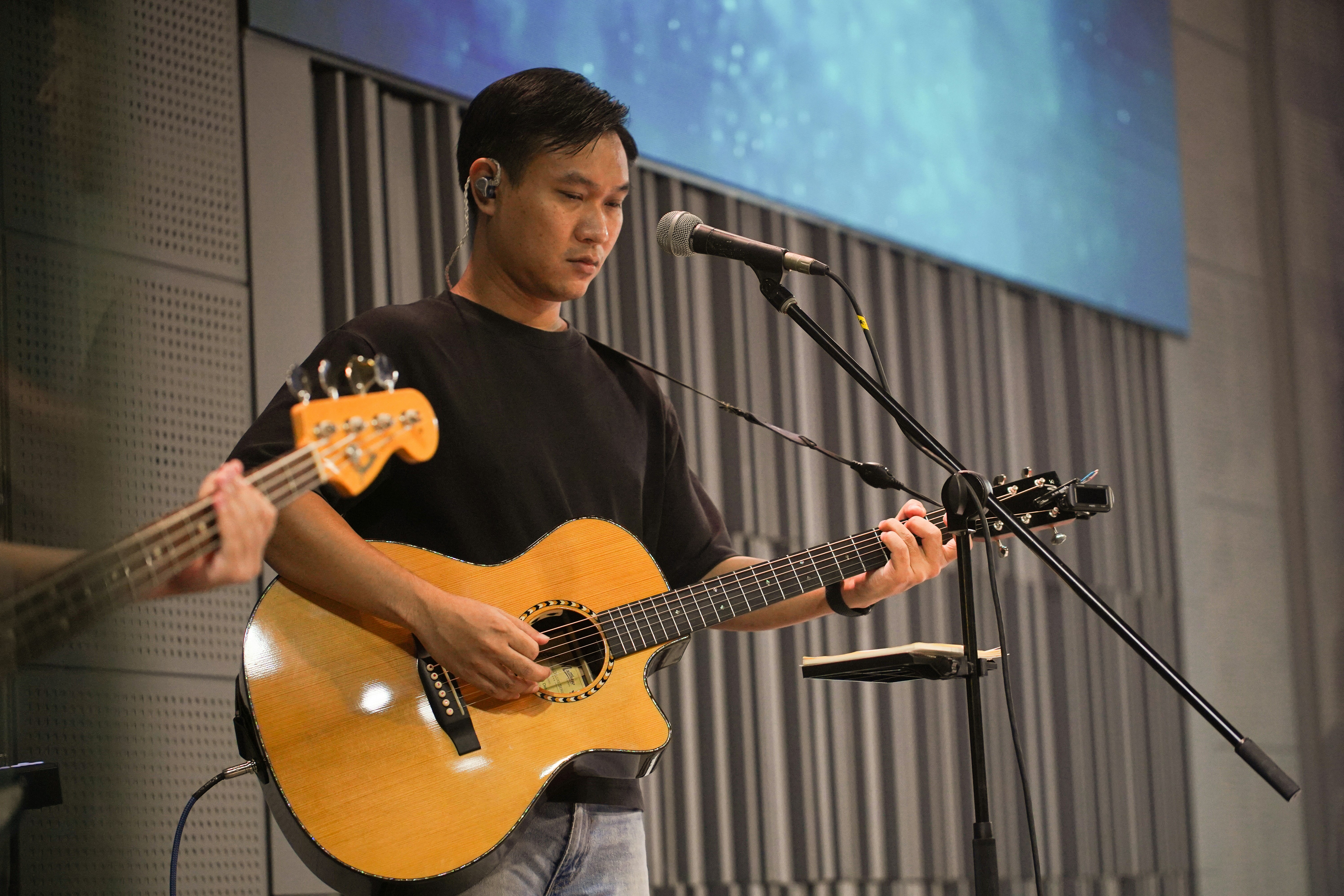 Man playing acoustic guitar on stage