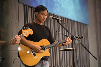 Man playing acoustic guitar on stage