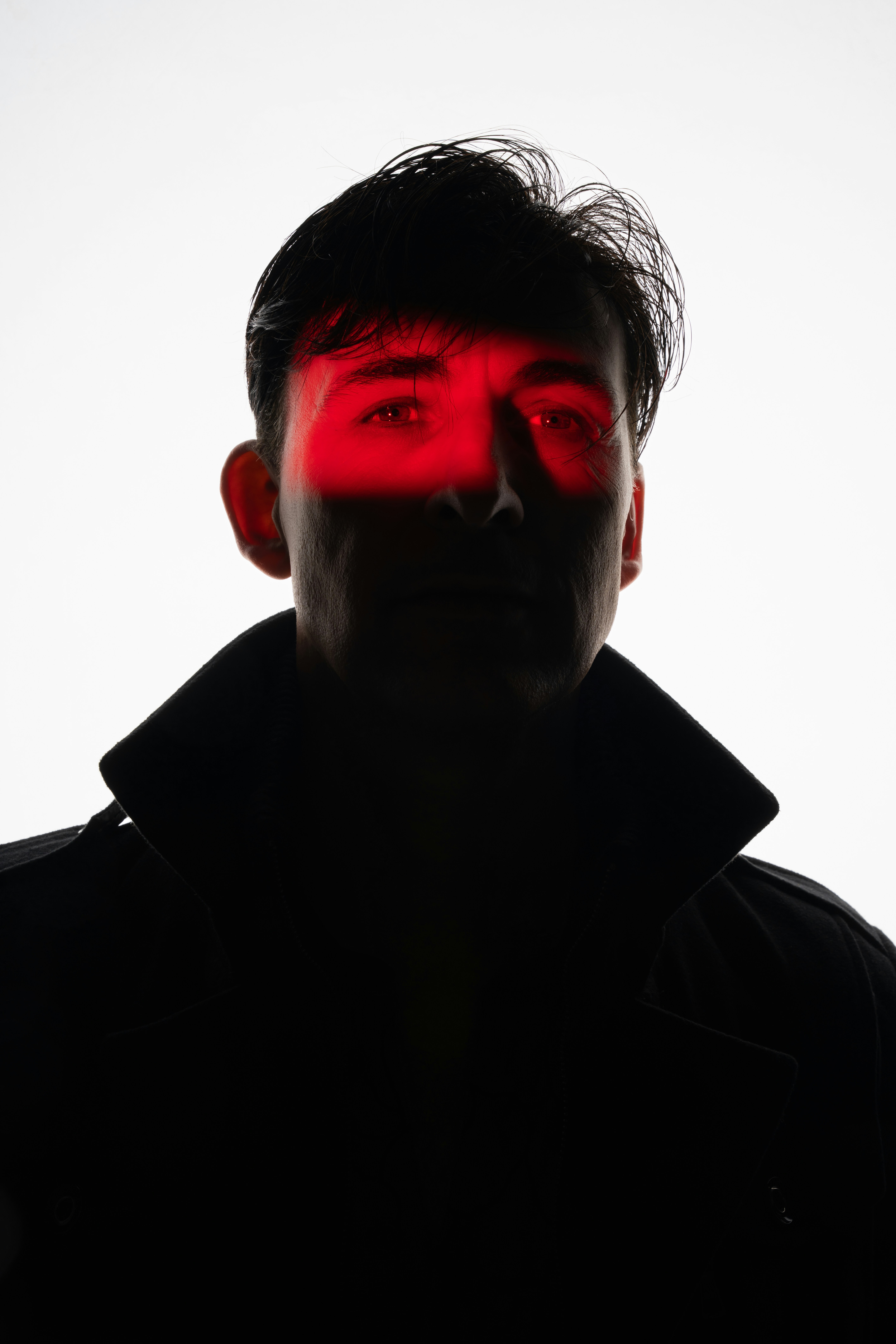Photo of Man with red light across eyes and over eyes by Jay Soundo