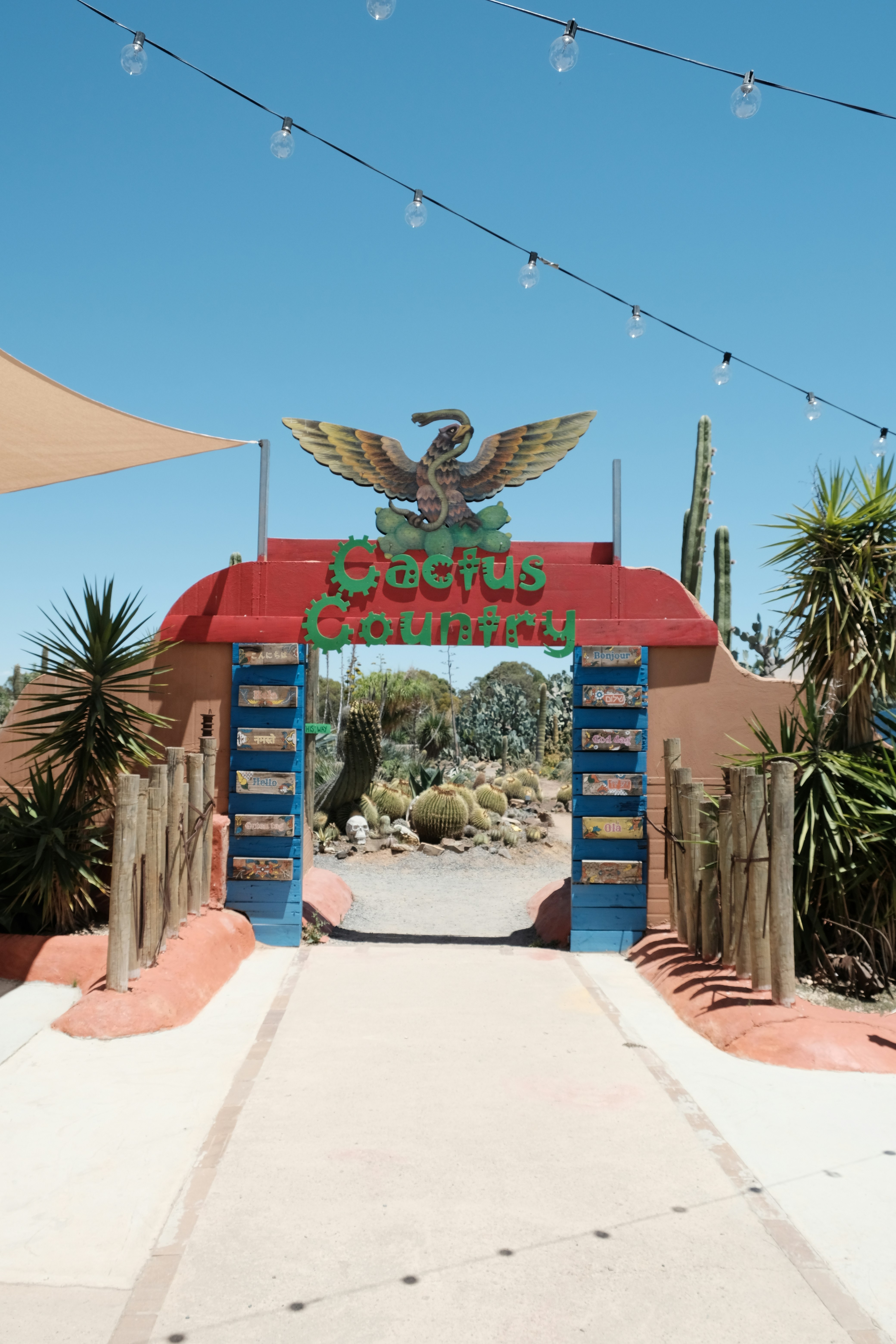 Entrance to a cactus garden with an eagle emblem.