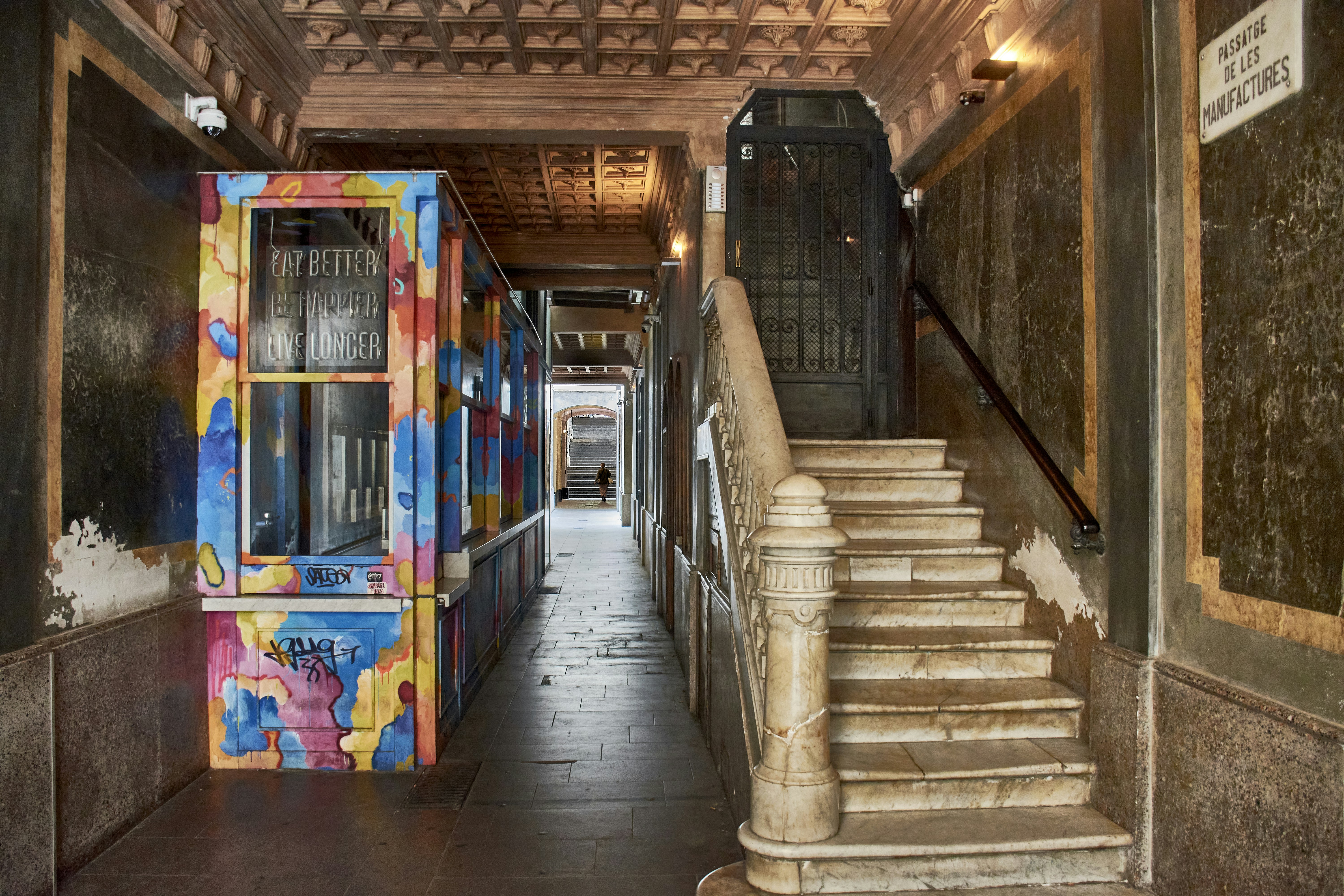 Colorful graffiti art adorns a hallway with stairs.