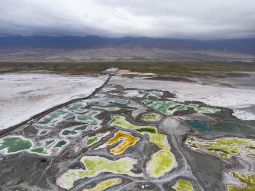 Colorful salt flats with mountains in the background