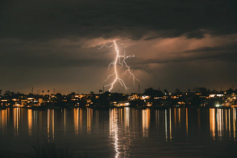 Florida lightning strikes over a city skyline at night.