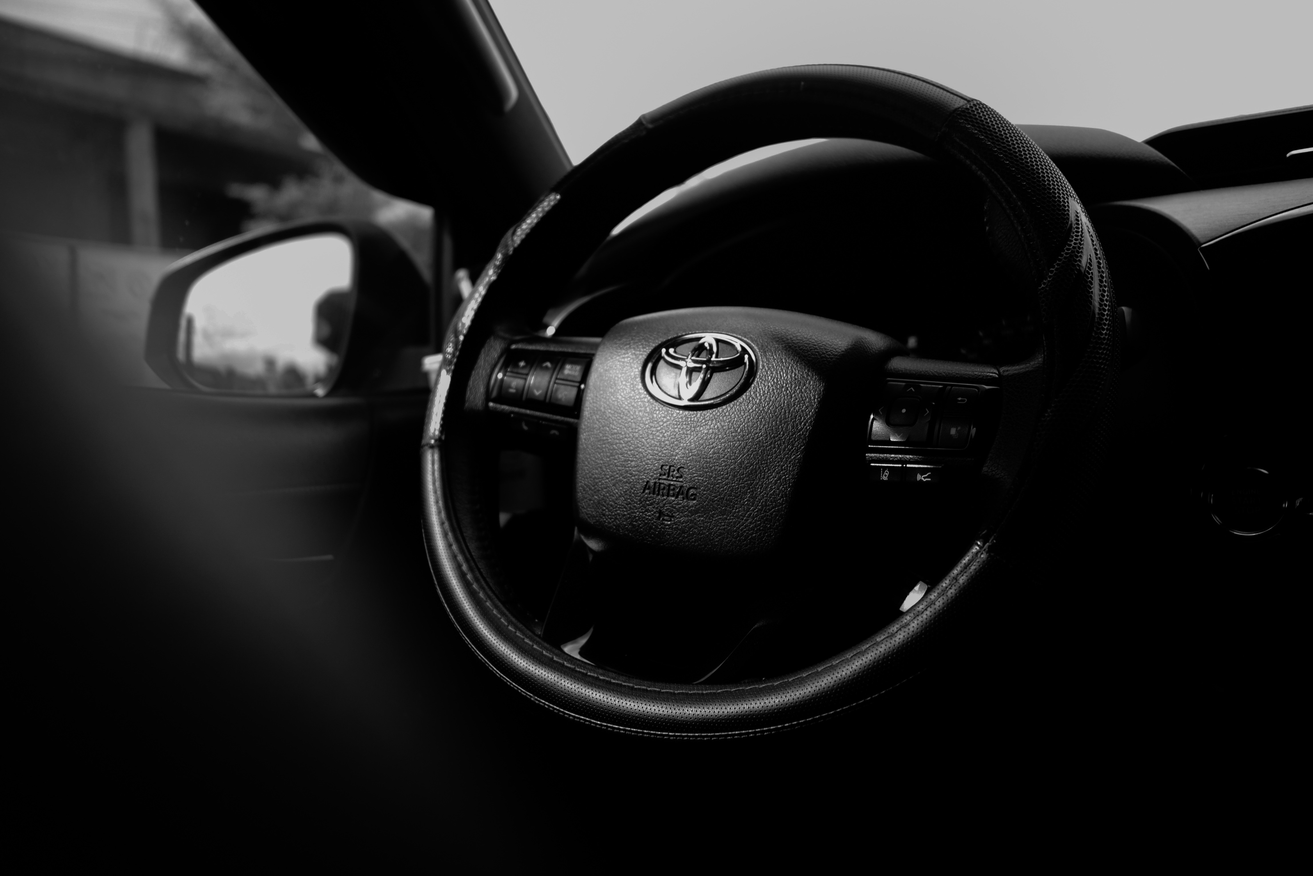 Close-up of a toyota steering wheel inside a car