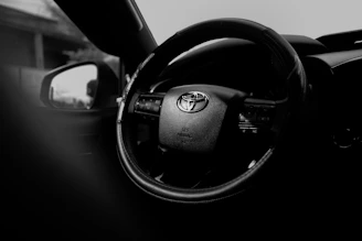 Close-up of a toyota steering wheel inside a car