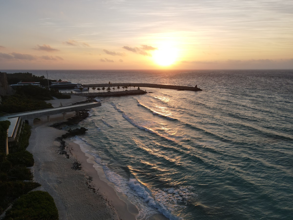 Sunrise over a tranquil ocean with a sandy beach