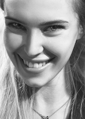 Close-up black and white of a smiling woman