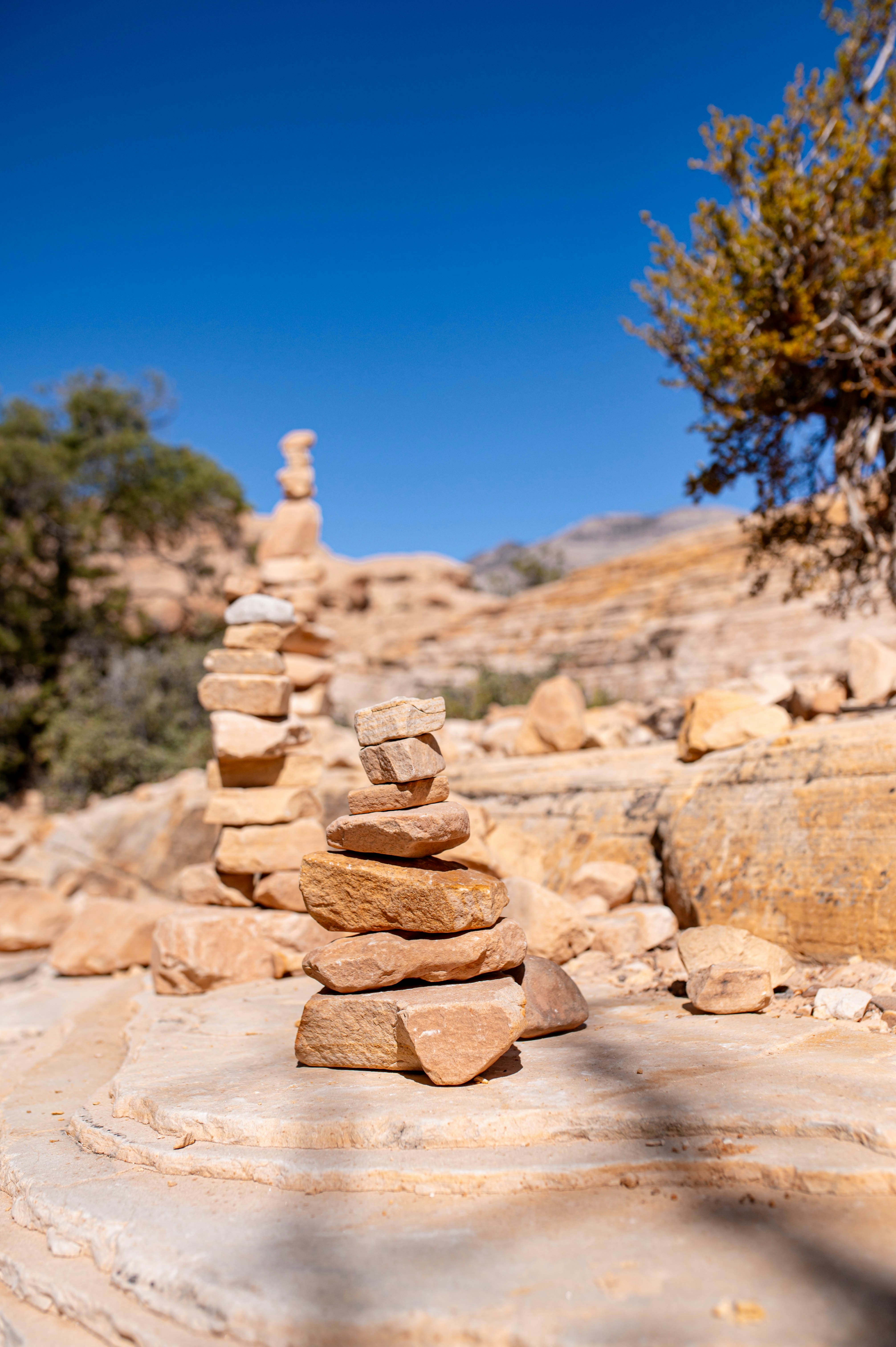 Stacked rocks on a sunny desert trail