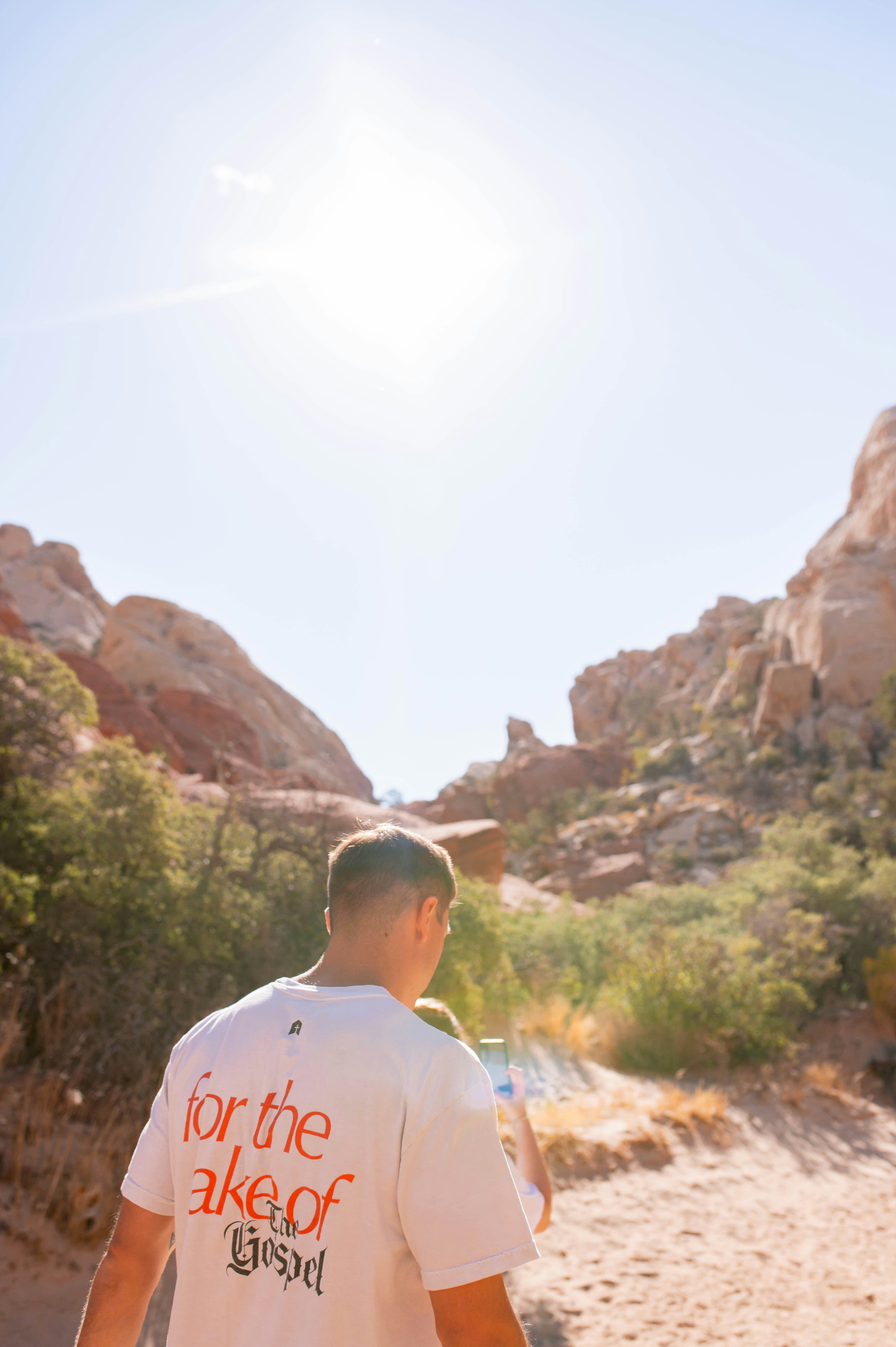 Man walking towards rocky desert landscape