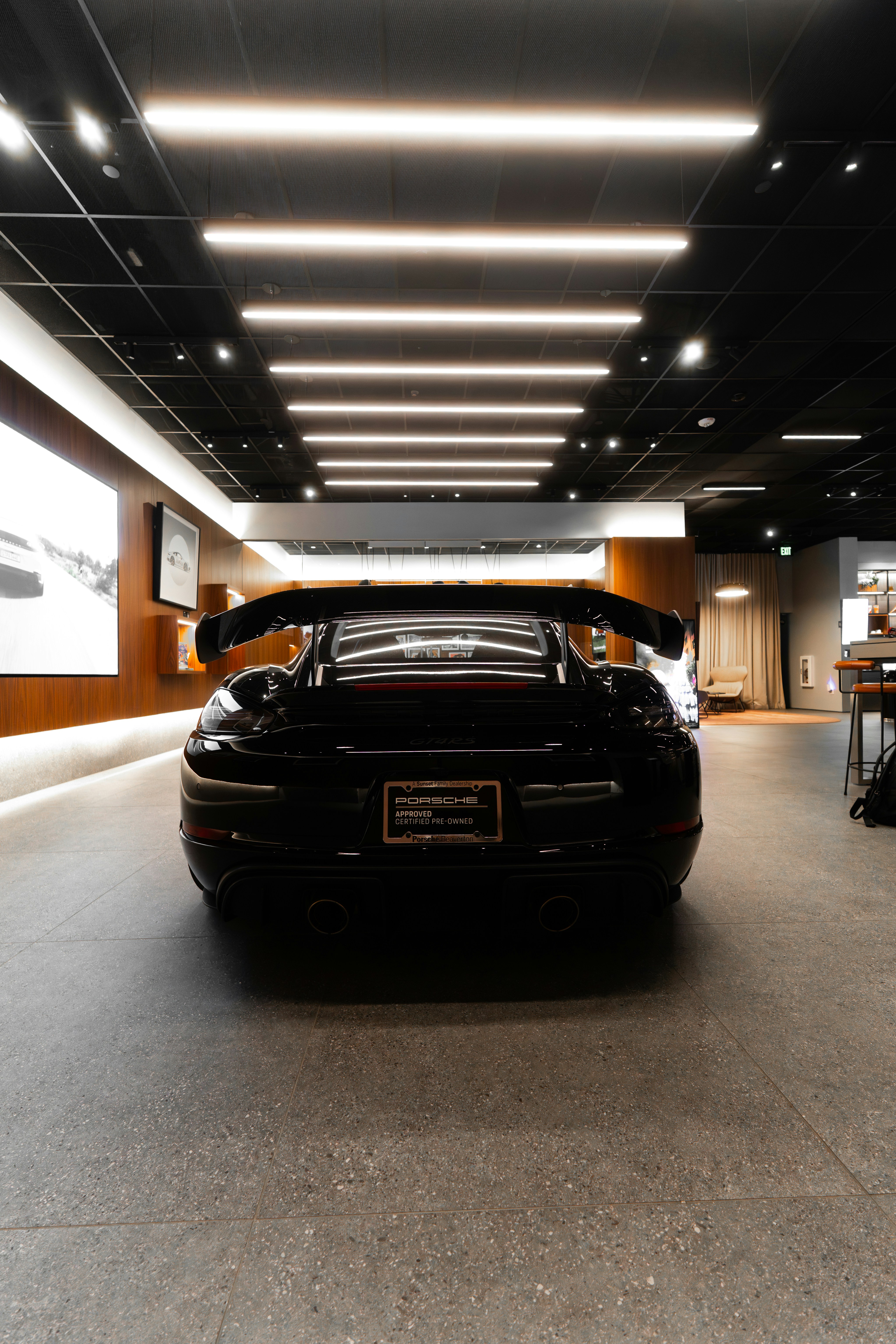 Rear view of a black sports car in showroom