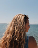 Woman with long blonde hair by the sea