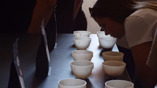 People smelling samples in small white cups