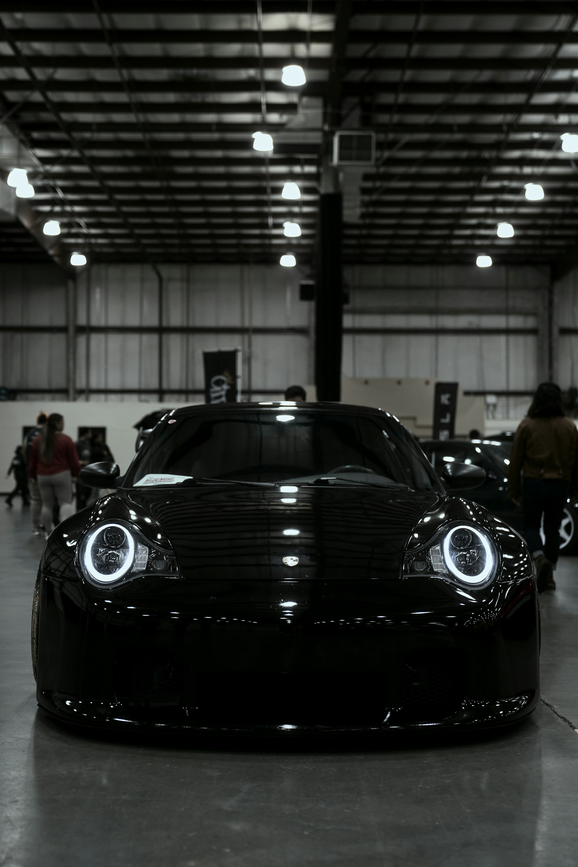 Black sports car with glowing white halo headlights