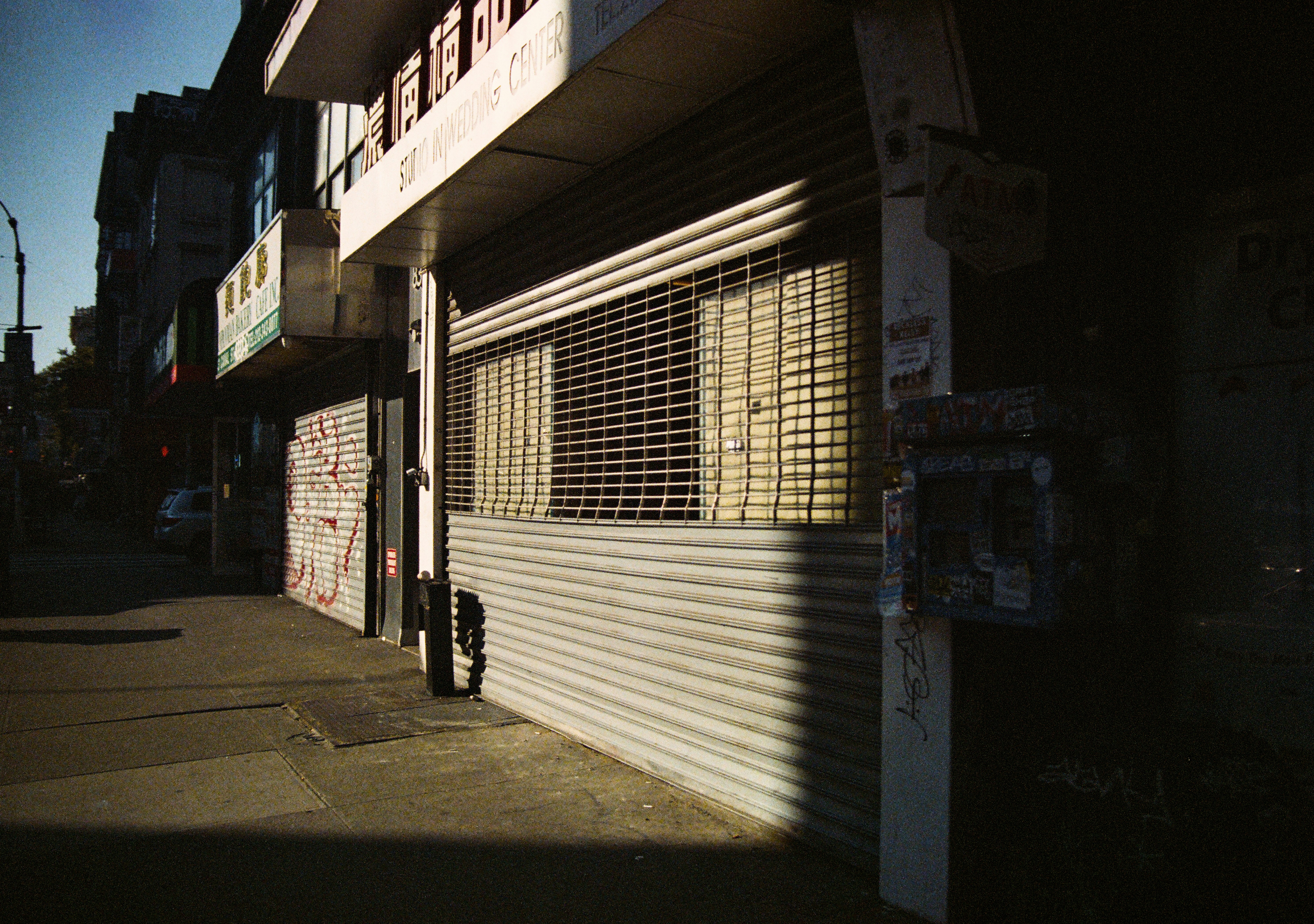 A closed storefront with metal security shutters.