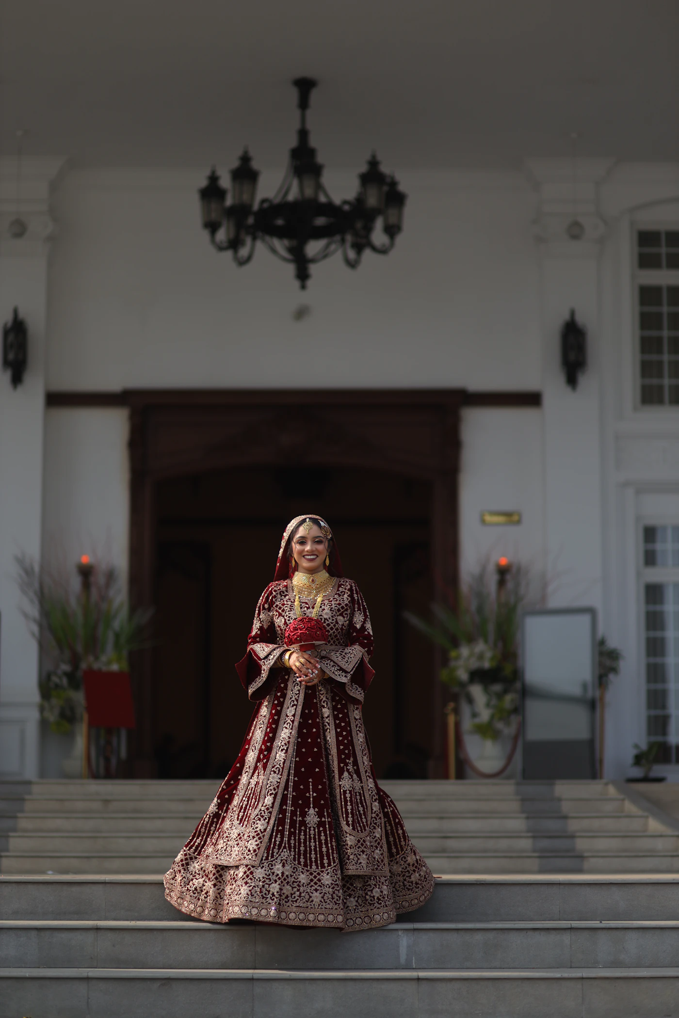 Indian bride in bridal lehenga with mehendi and jewellery