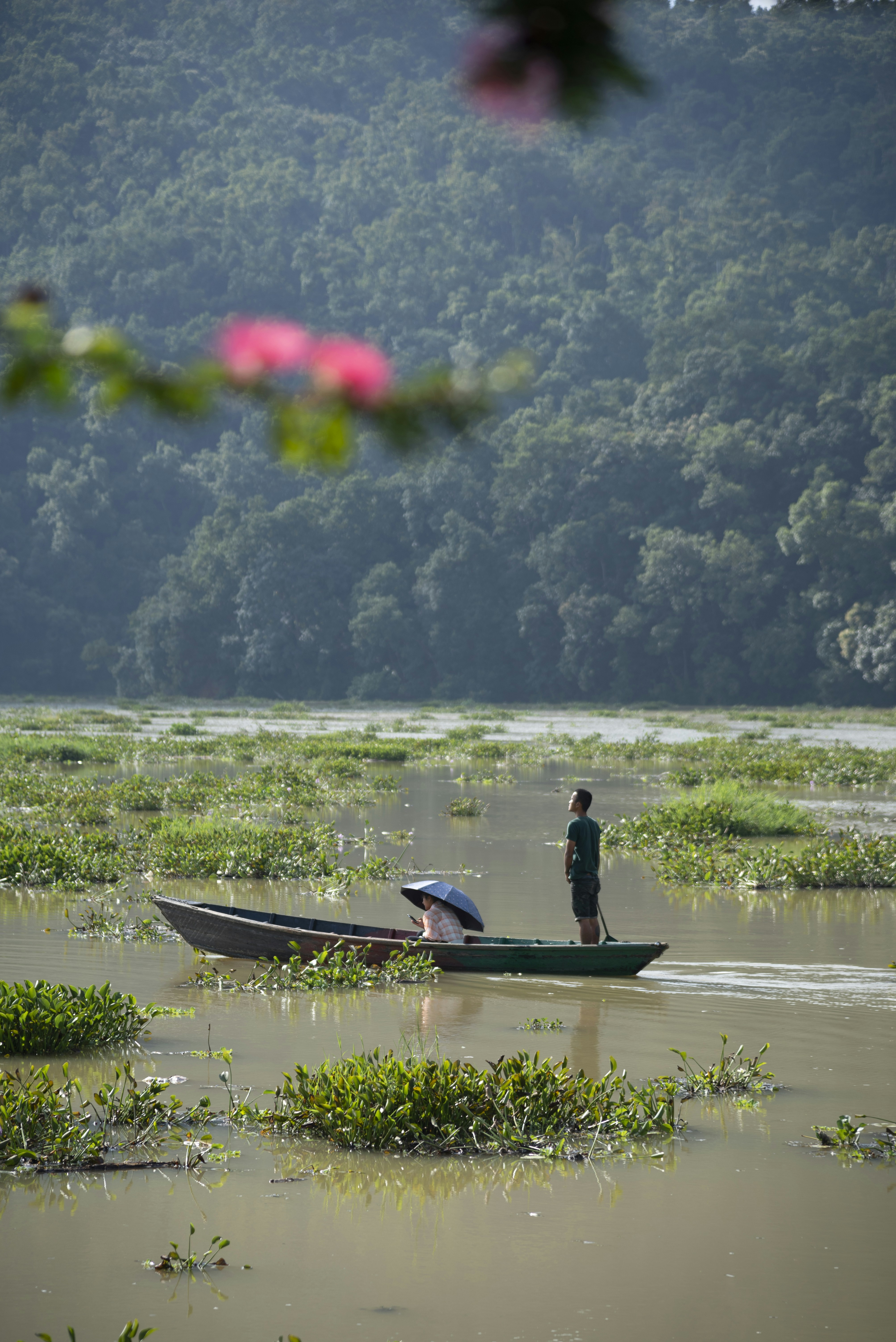 Man standing in a boat on a lake