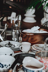 Assortment of vintage dishes and kitchenware on a table.