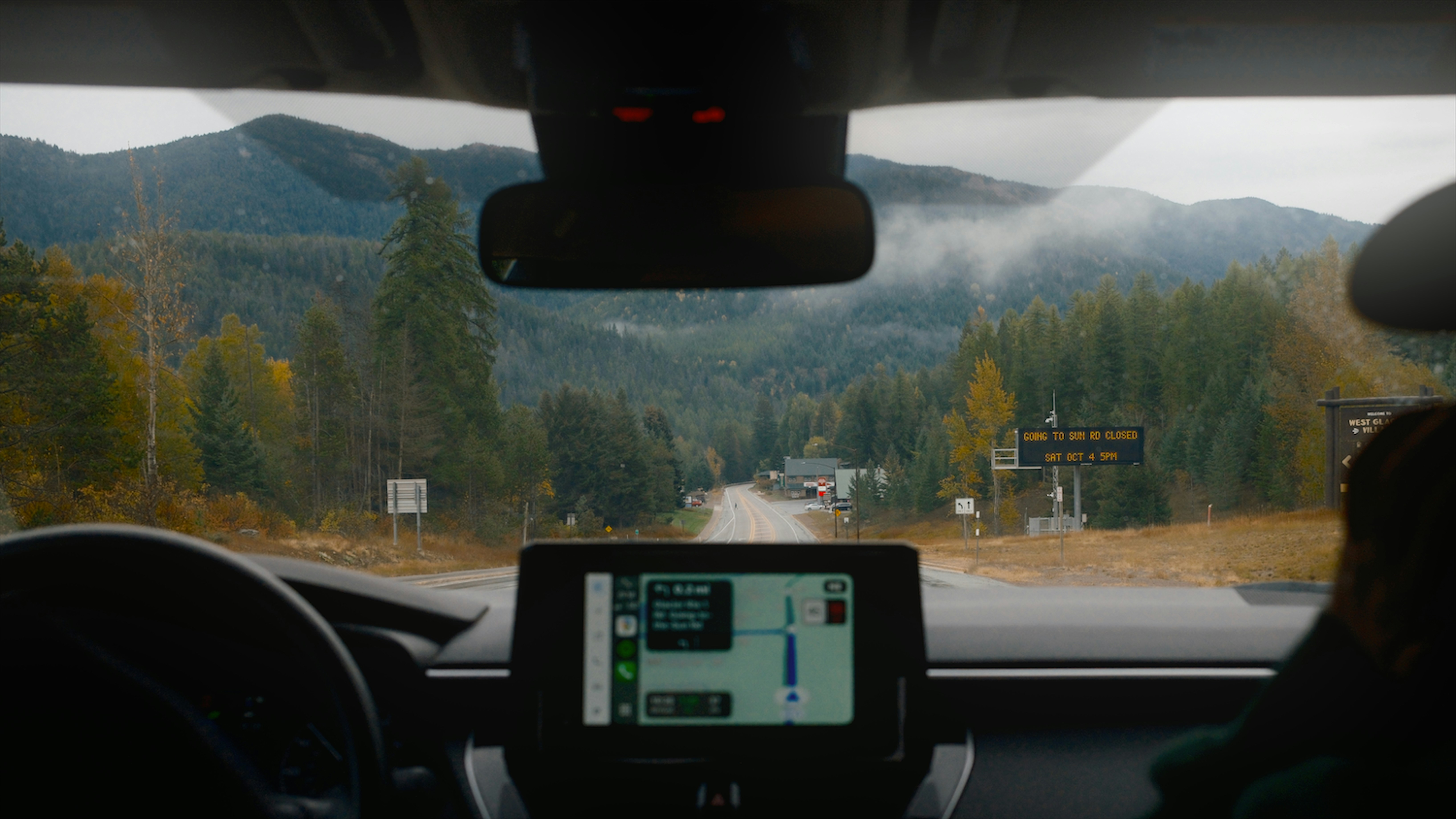 Driving through a scenic mountain road with gps navigation.