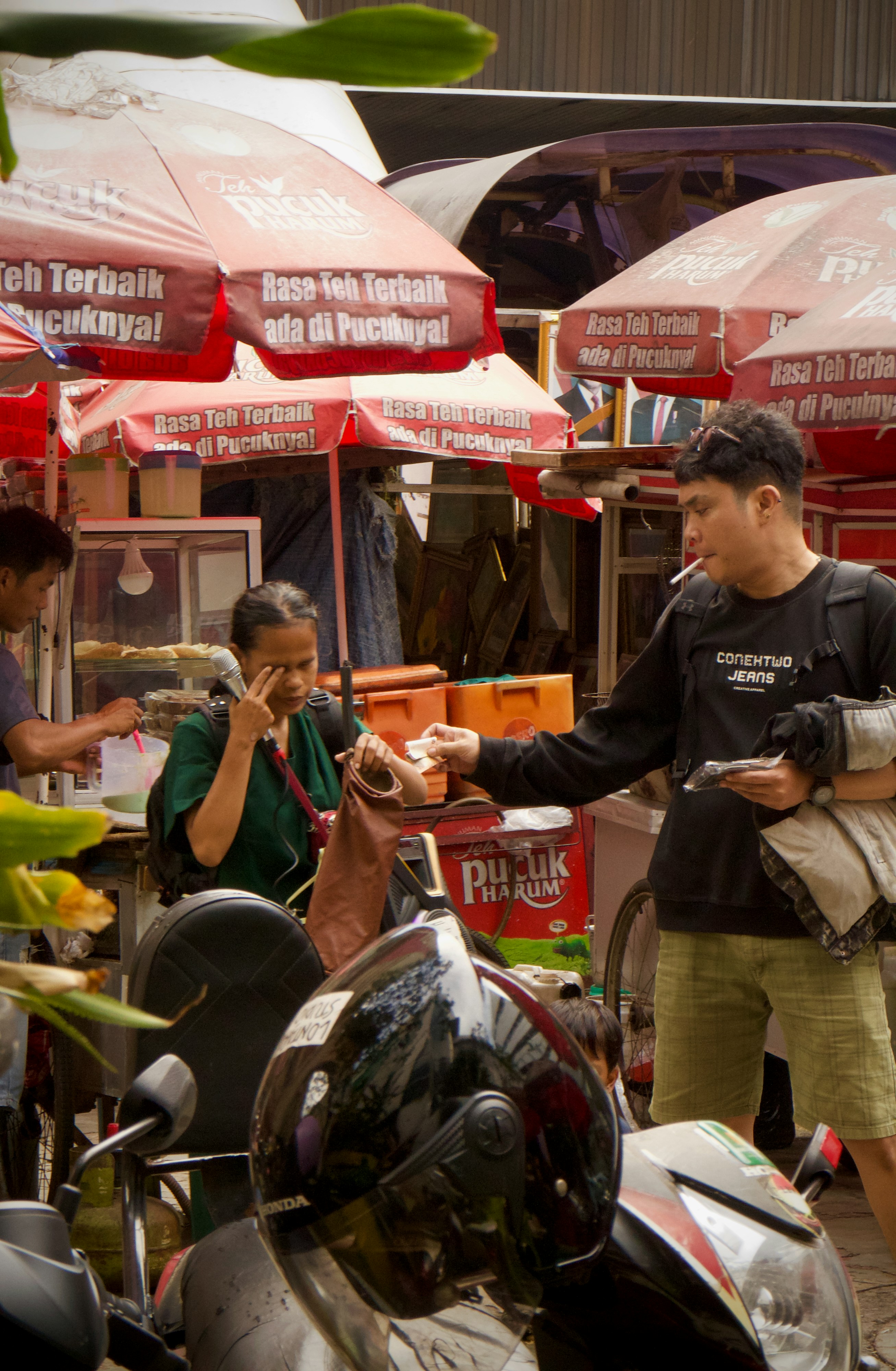 Man buys food from a street vendor