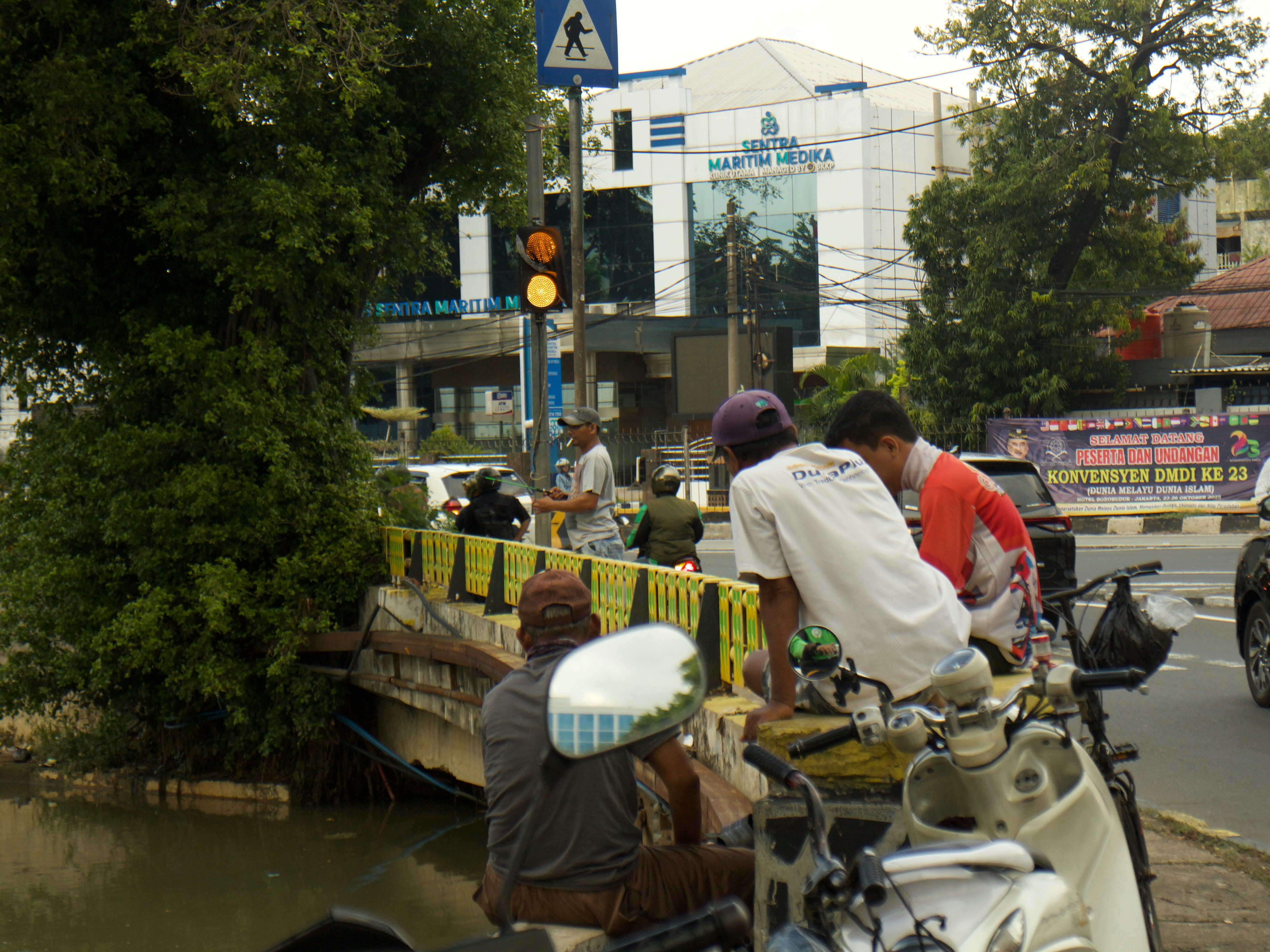 People gathered on a bridge over a canal