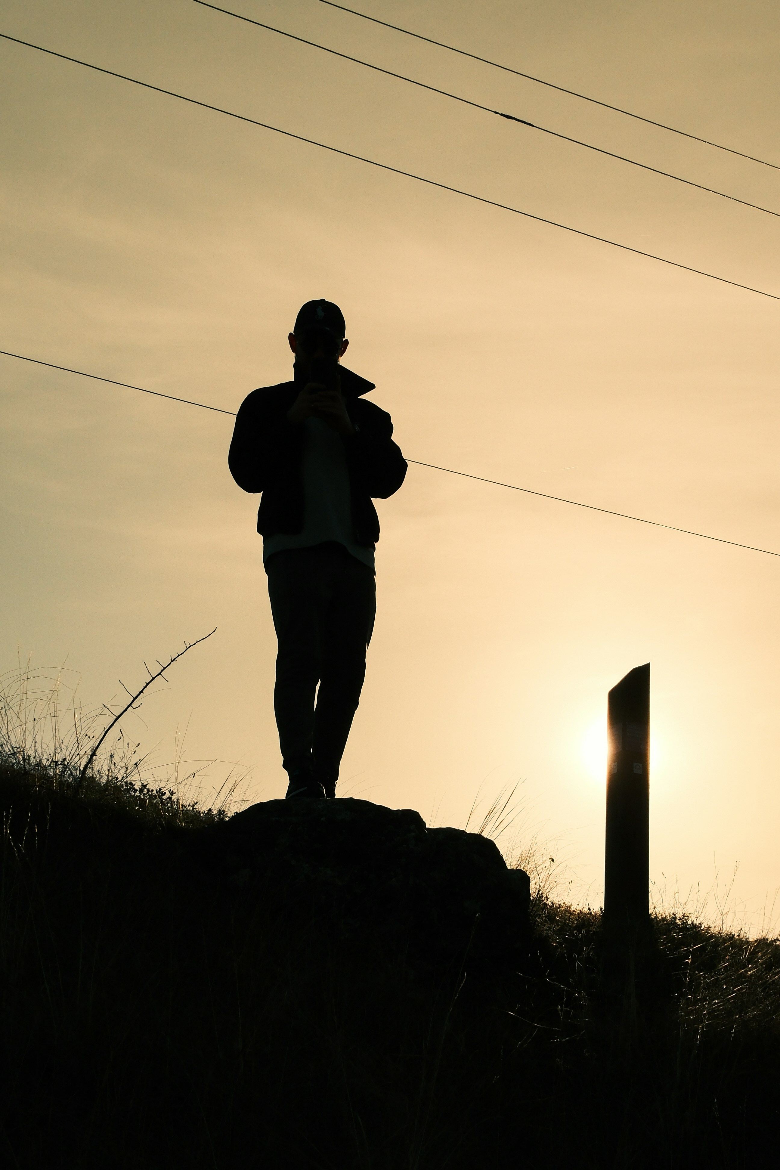 Man standing on a hill at sunset