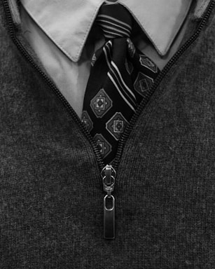 Close-up of a man's patterned tie and collared shirt.