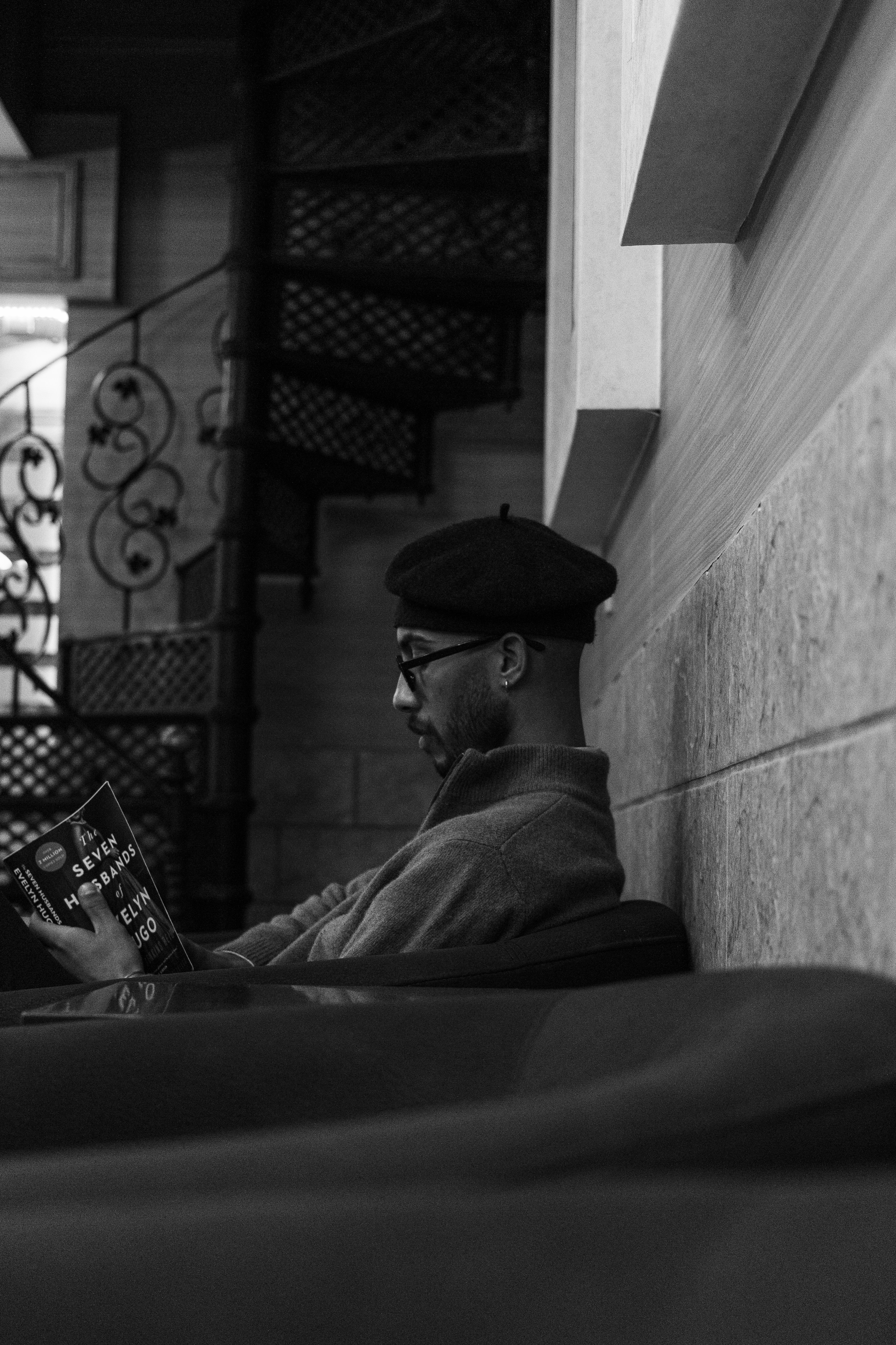Man wearing a beret reading a book