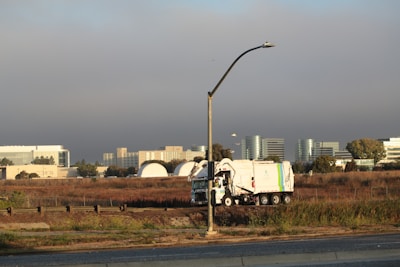 Garbage truck driving past office buildings