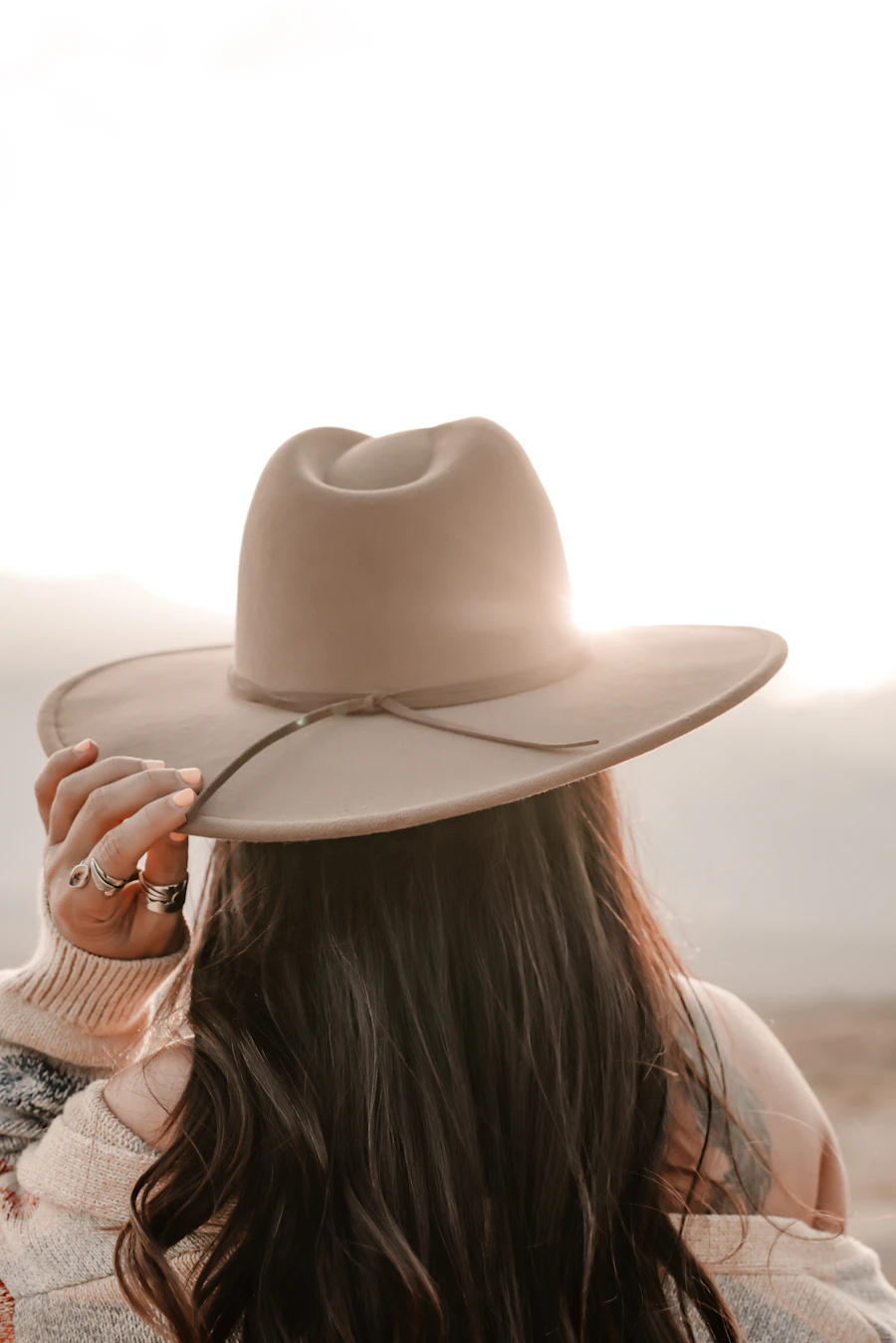 Neutral wide-brim western hat worn outdoors