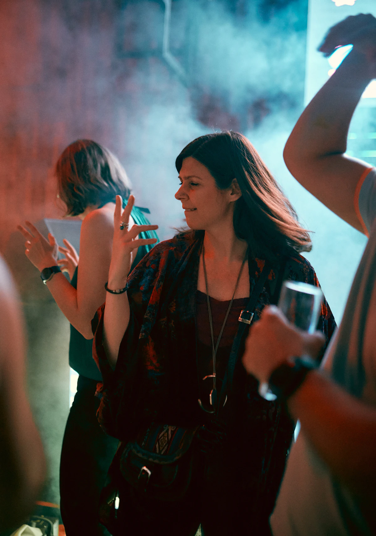 People dancing in a smoky nightclub