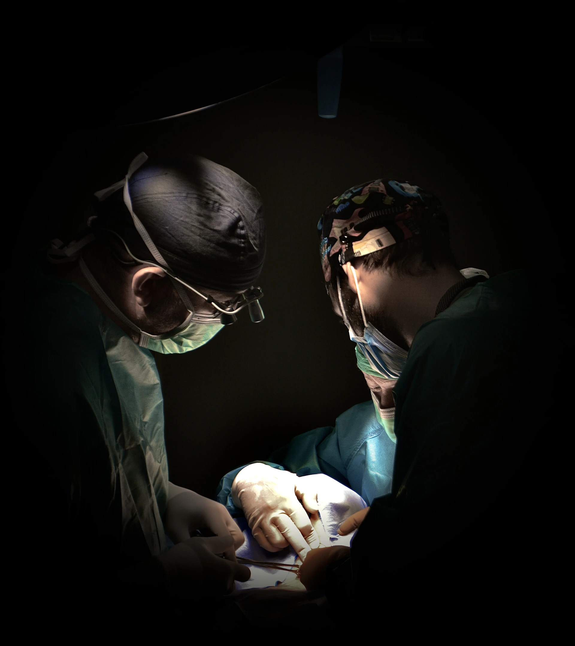 Surgeons performing surgery under bright lights