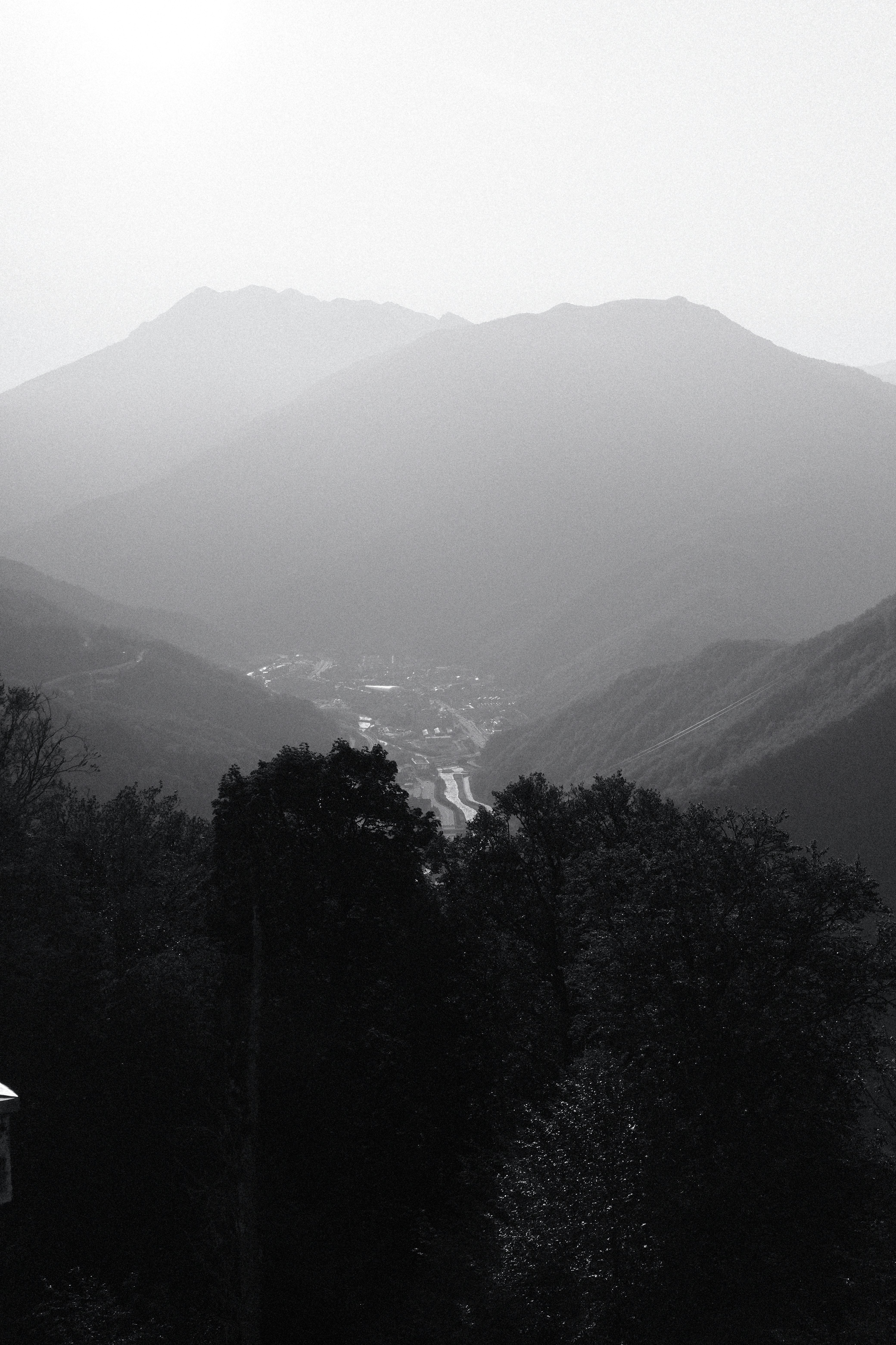 Misty mountains with a village nestled in the valley.