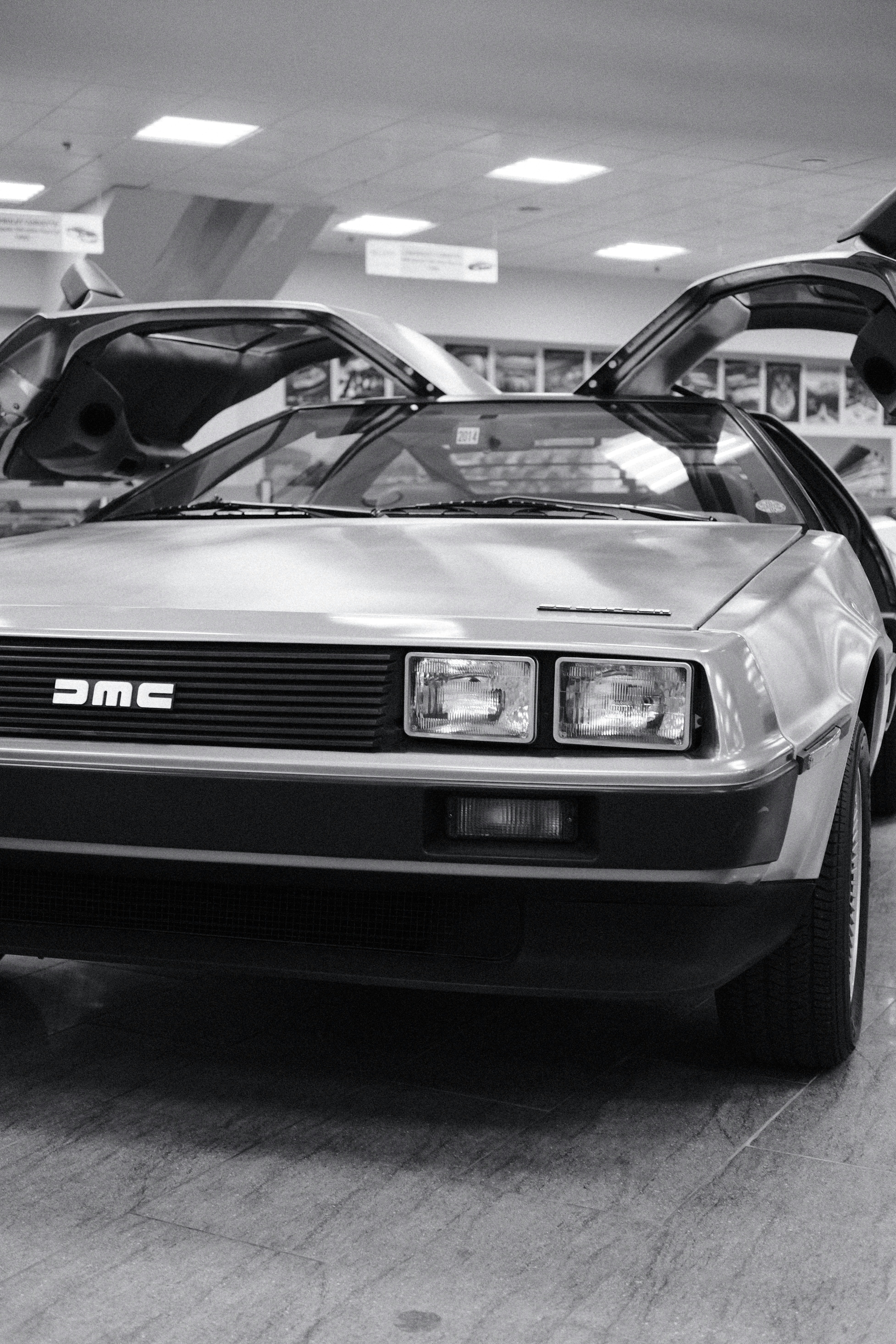 A delorean dmc-12 car with doors open